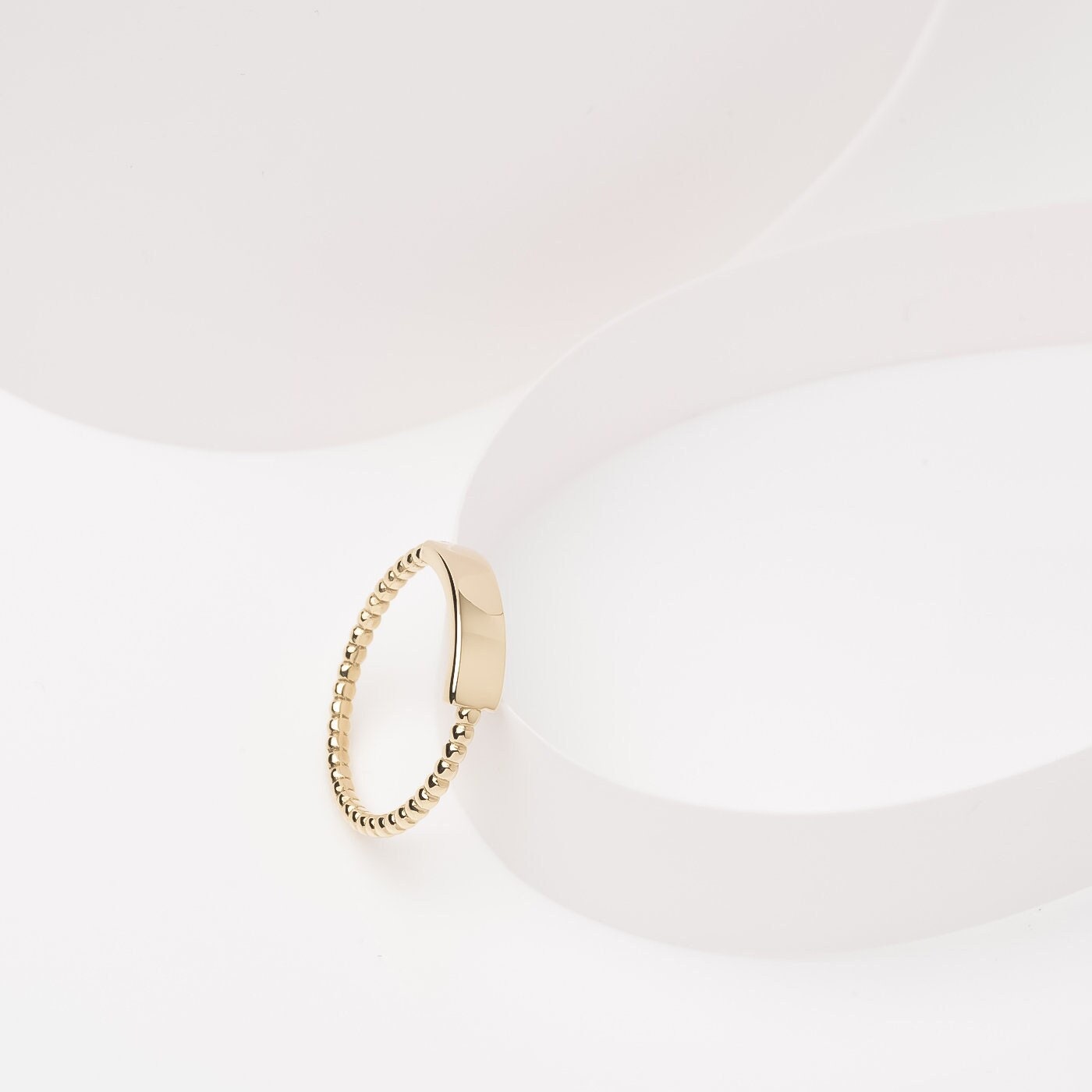 A personalized bar ring for women, crafted in 14k gold and featuring a beaded design.