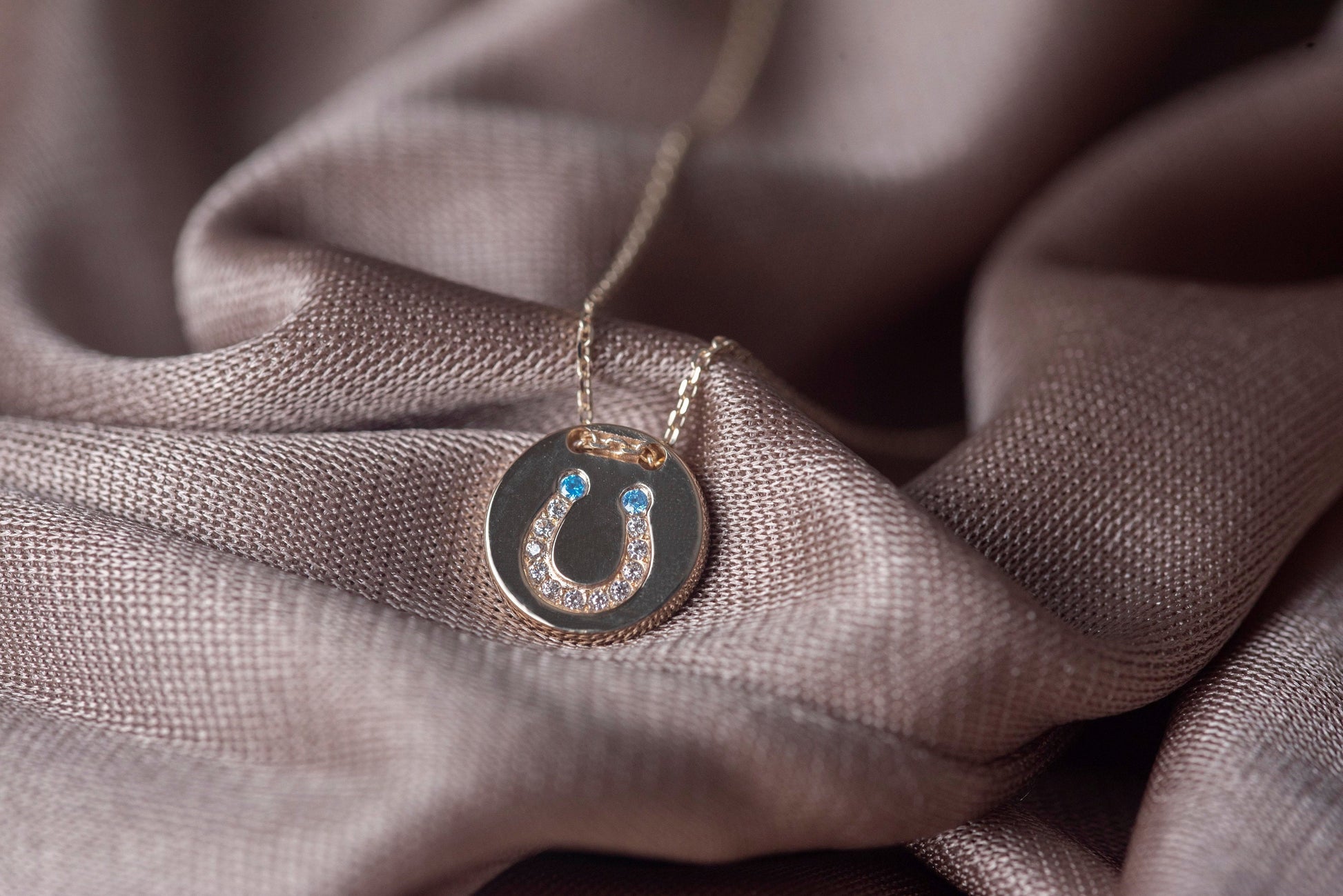 coin necklace in 14k gold with paved horseshoe