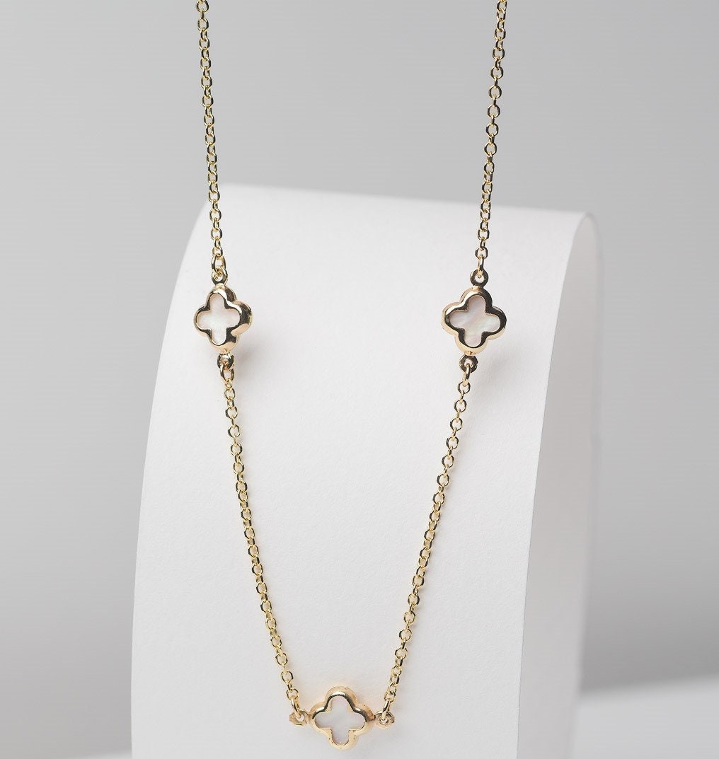 Elegant Four Leaf Clover Necklace featuring three mother-of-pearl motifs set in 14k gold.