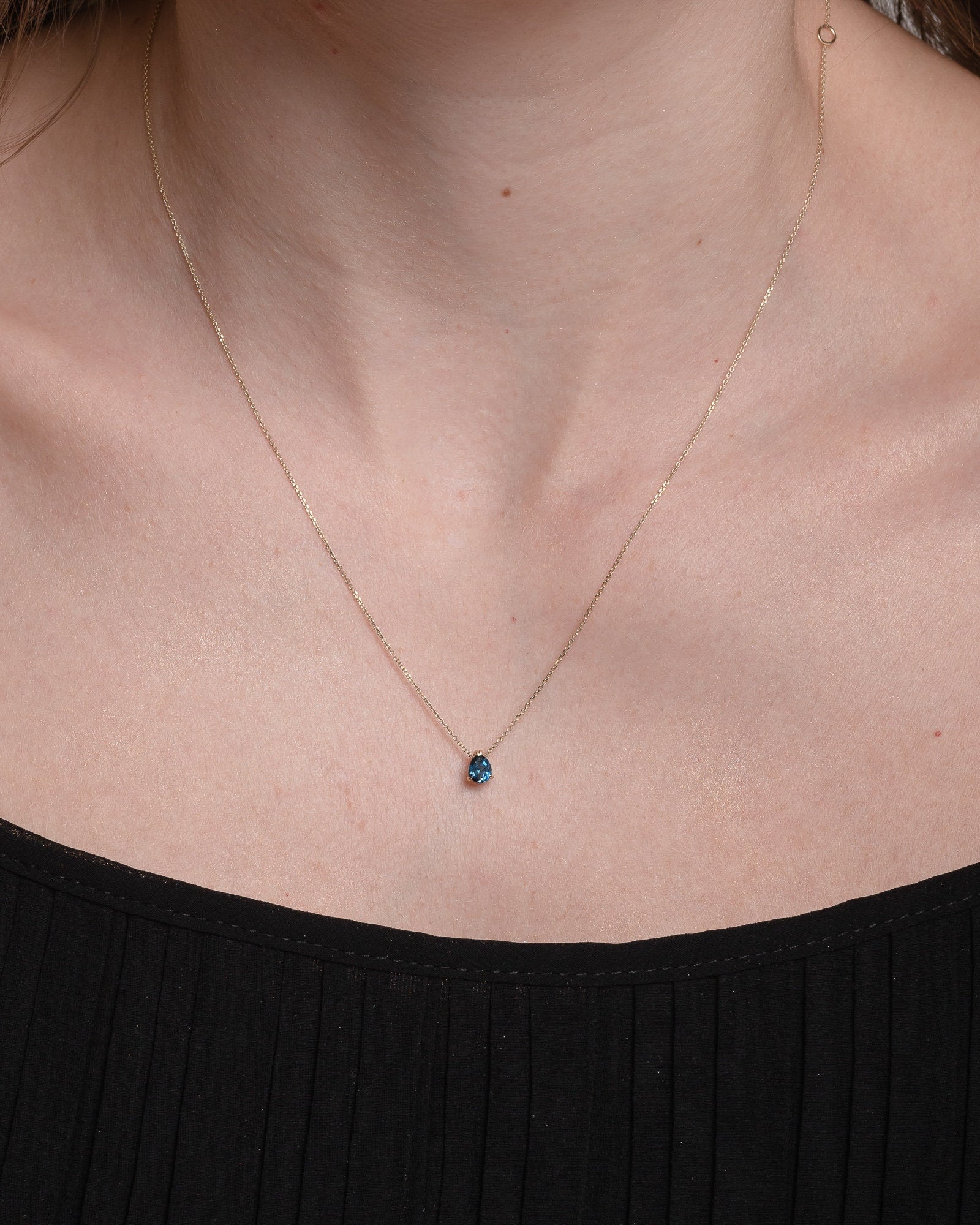 drop  blue aquamarine necklace in 14k white gold worn by a model 