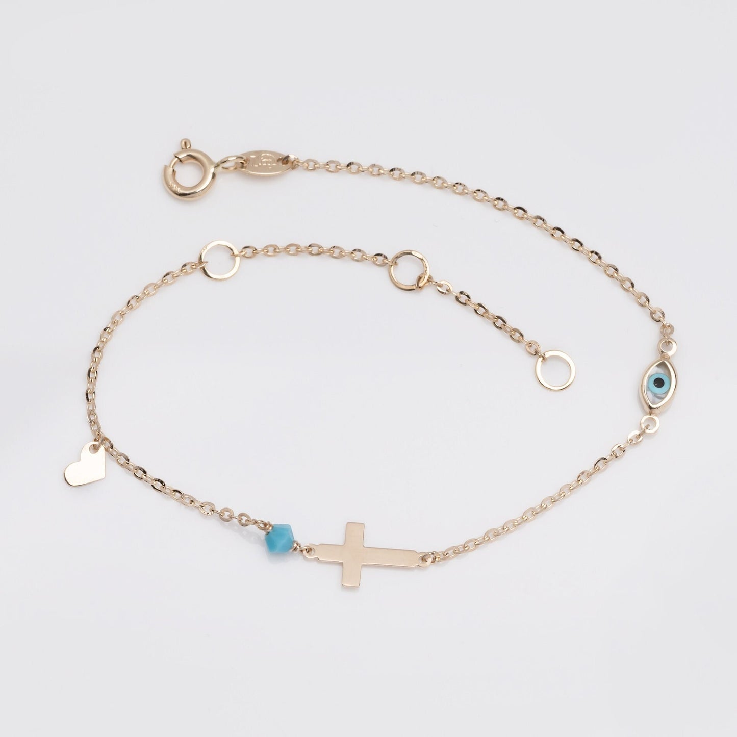 14k gold charm bracelet with cross, evil eye, heart, turquoise