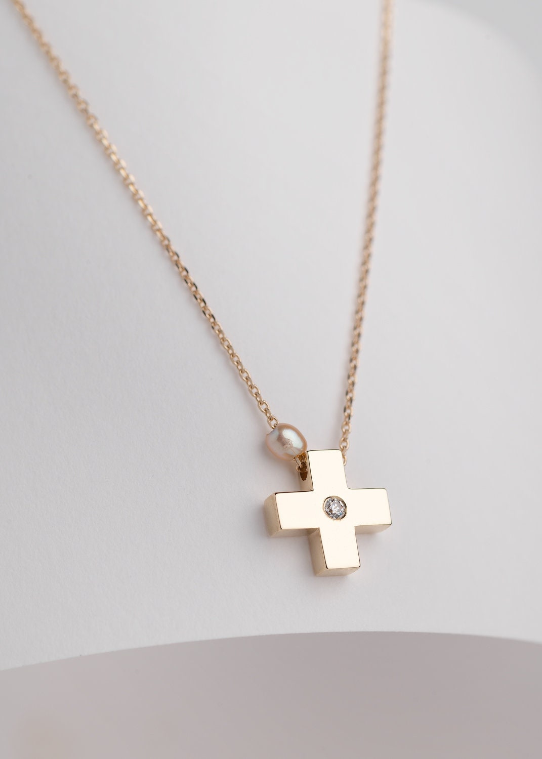 small diamond cross necklace with a small pearl in 14k yellow gold for women 