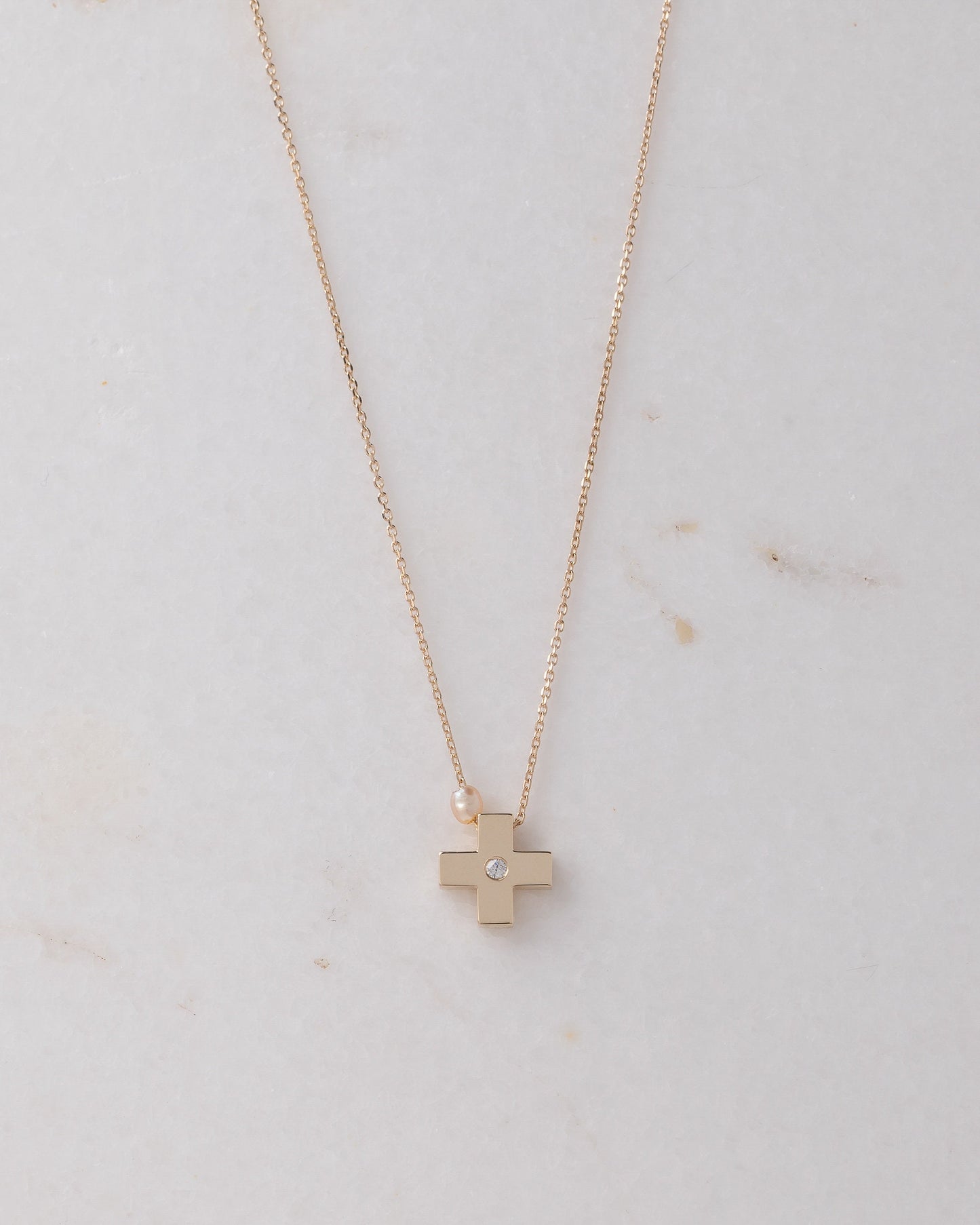 small diamond cross necklace with a small pearl in 14k yellow gold for women 