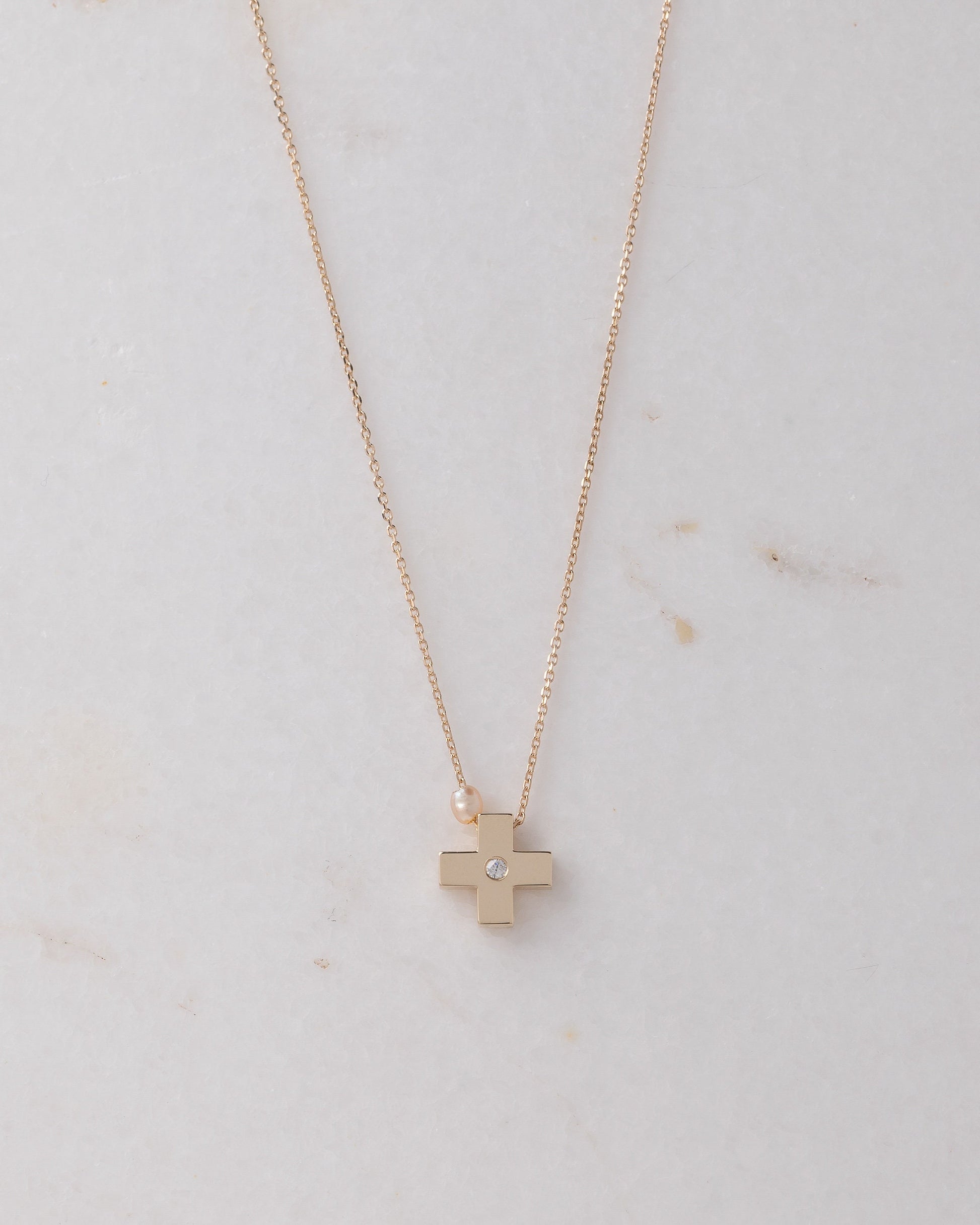 small diamond cross necklace with a small pearl in 14k yellow gold for women 