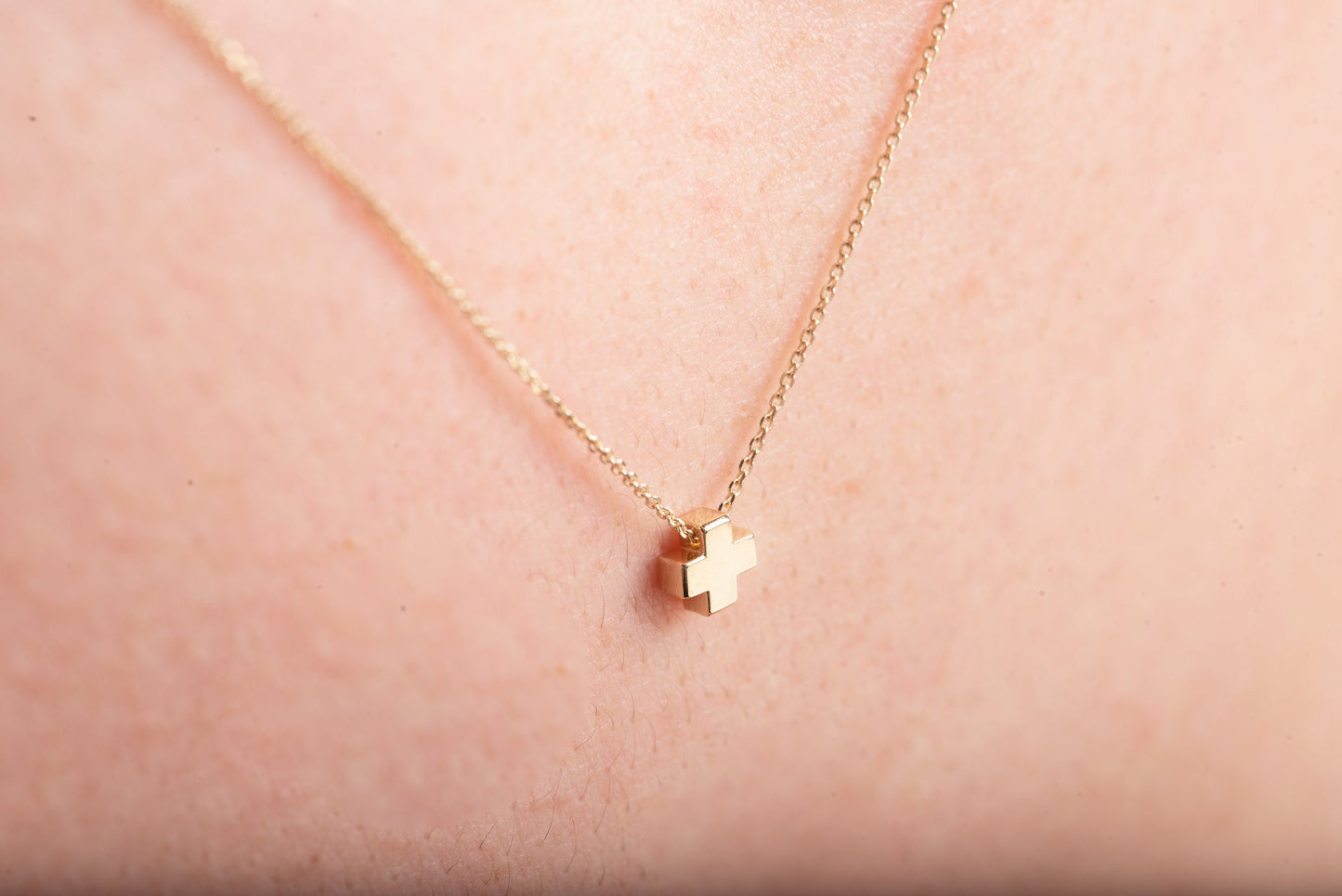 square small necklace in 14k yellow gold worn by a model 