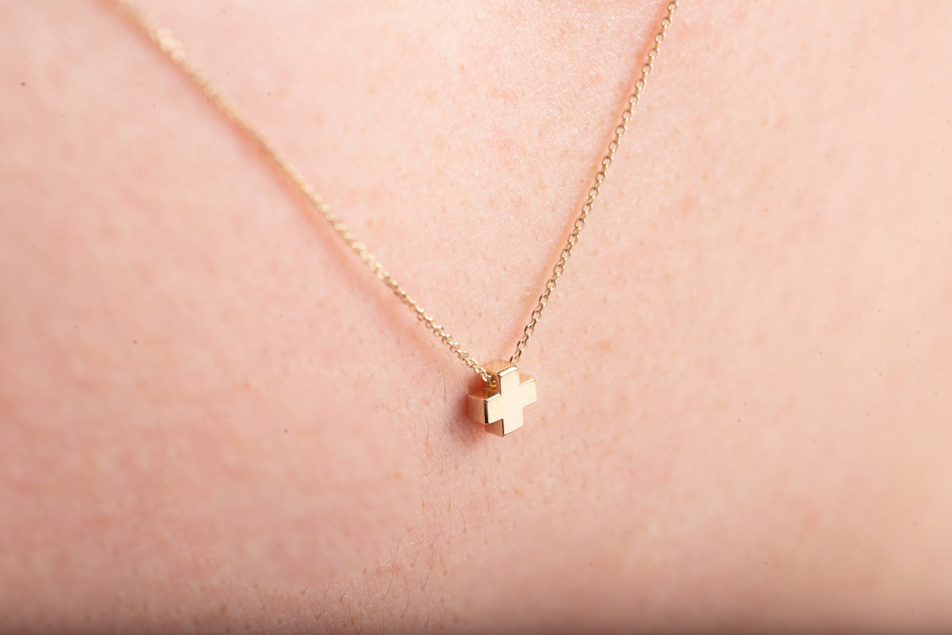 square small necklace in 14k yellow gold worn by a model 