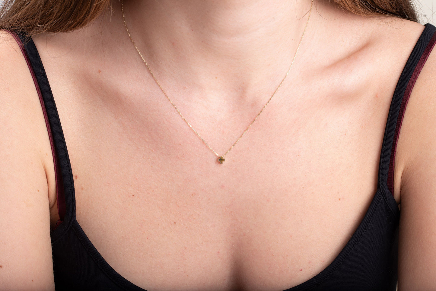 square small necklace in 14k yellow gold worn by a model 