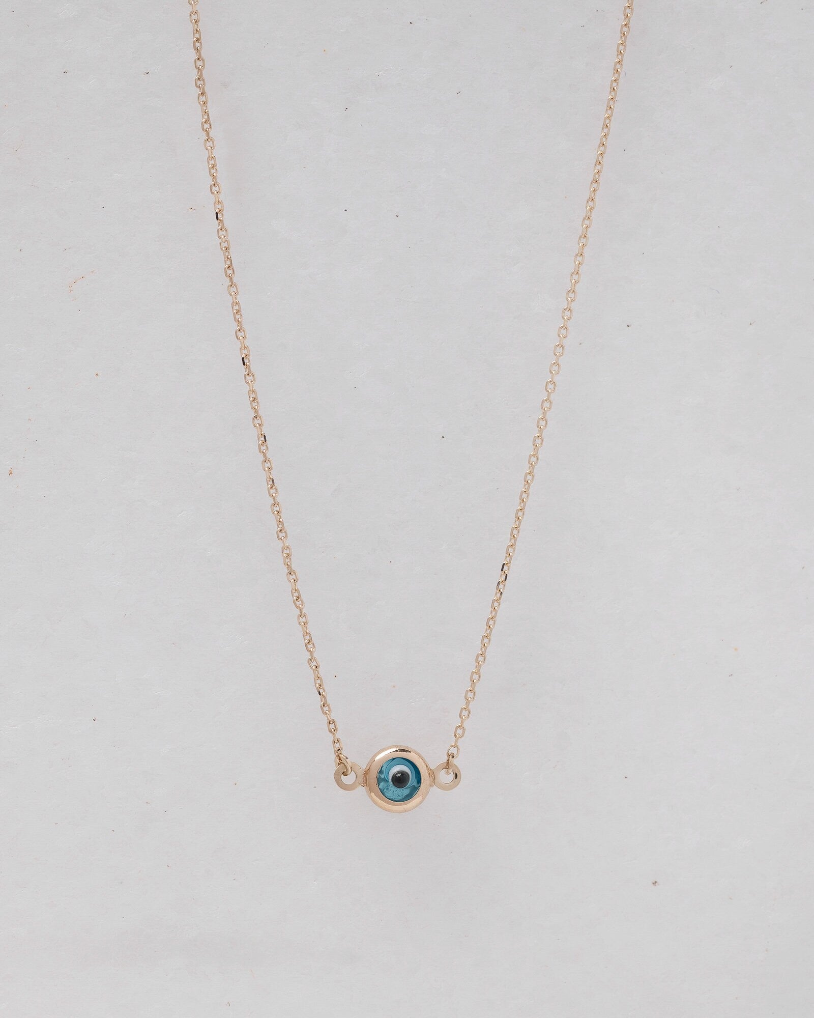 Murano glass double-sided evil eye necklace in 14k gold. 