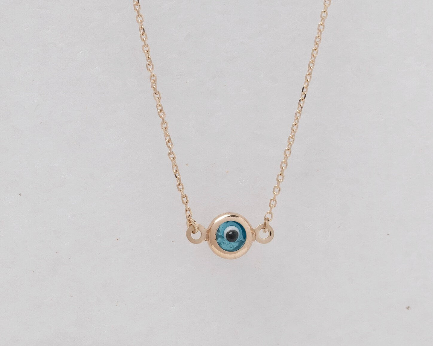 Murano glass double-sided evil eye necklace in 14k gold.