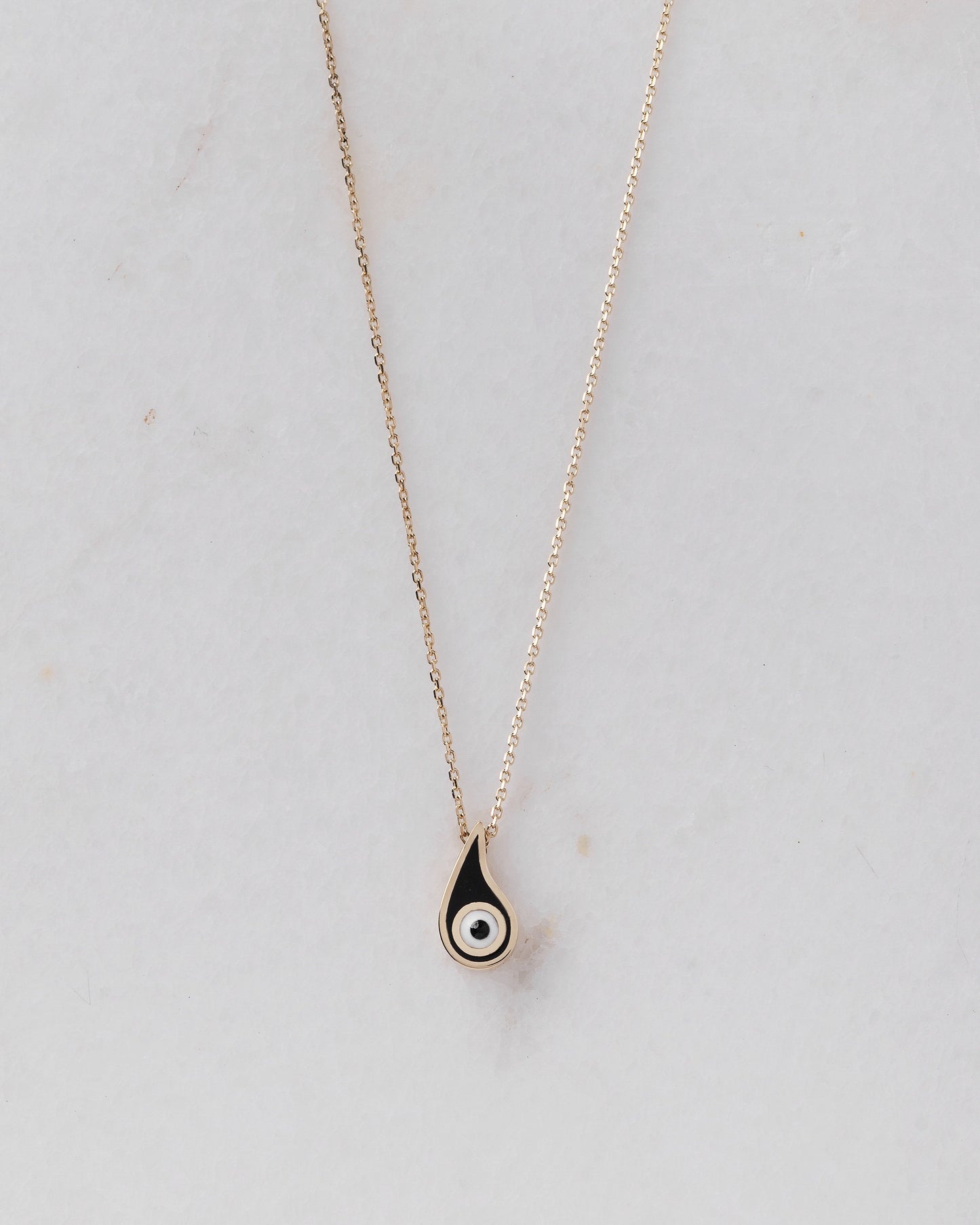 Evil Eye Paisley Necklace for women, crafted in 14k gold with black enamel detailing.