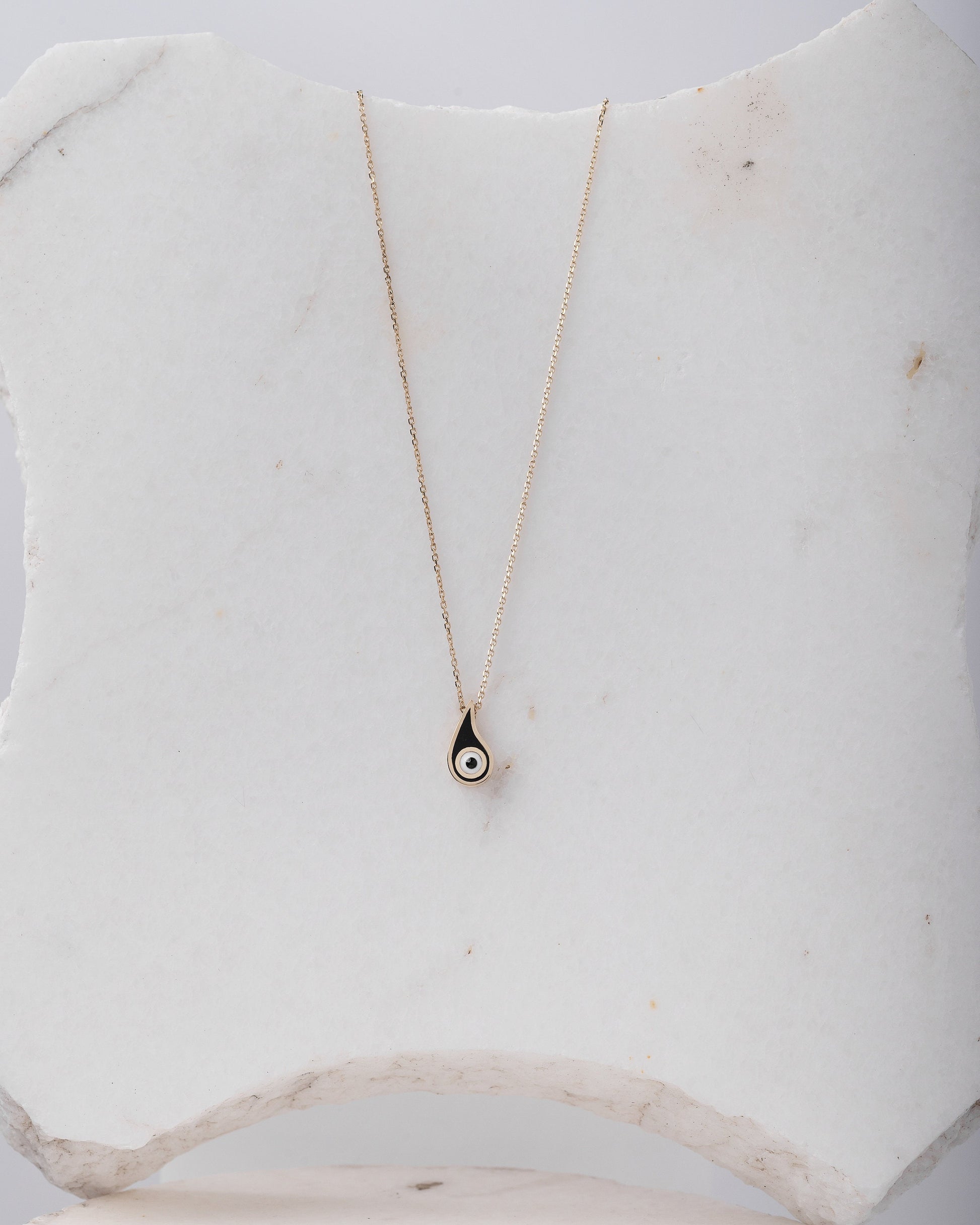 Evil Eye Paisley Necklace for women, crafted in 14k gold with black enamel detailing.