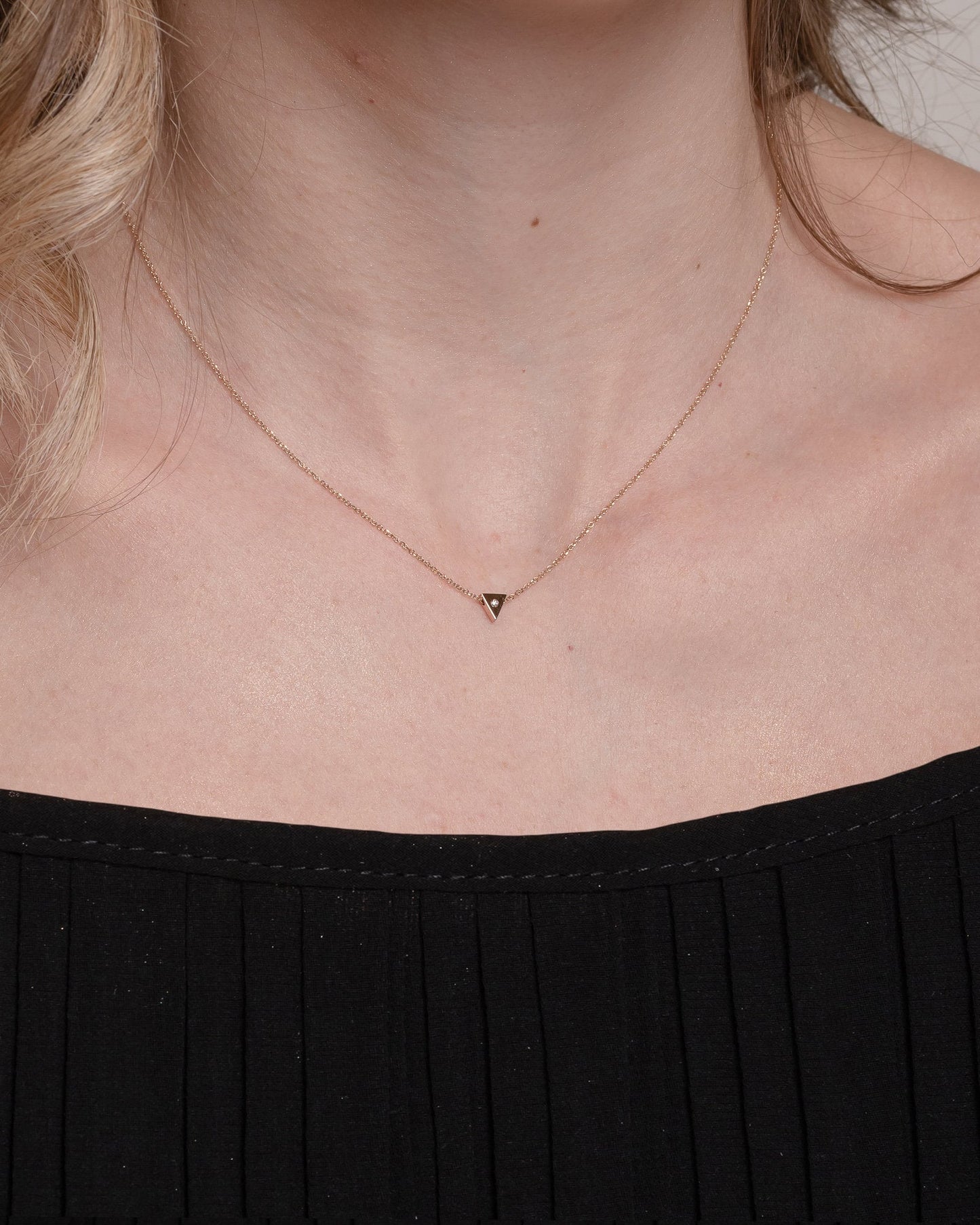 Triangle Diamond Necklace in 18K Gold worn by a model 