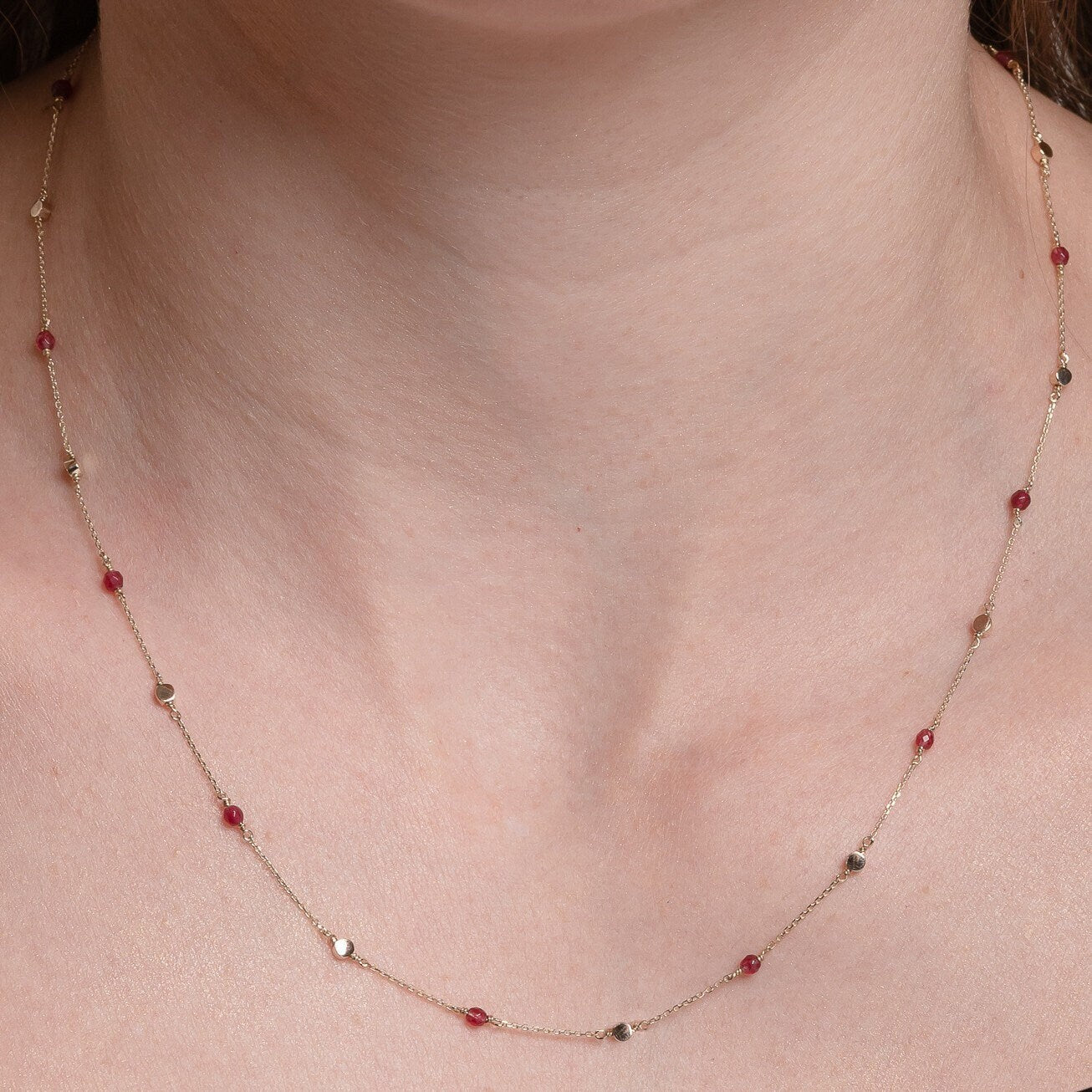 Station necklace featuring gold beads and tourmaline stones set in 14k gold.