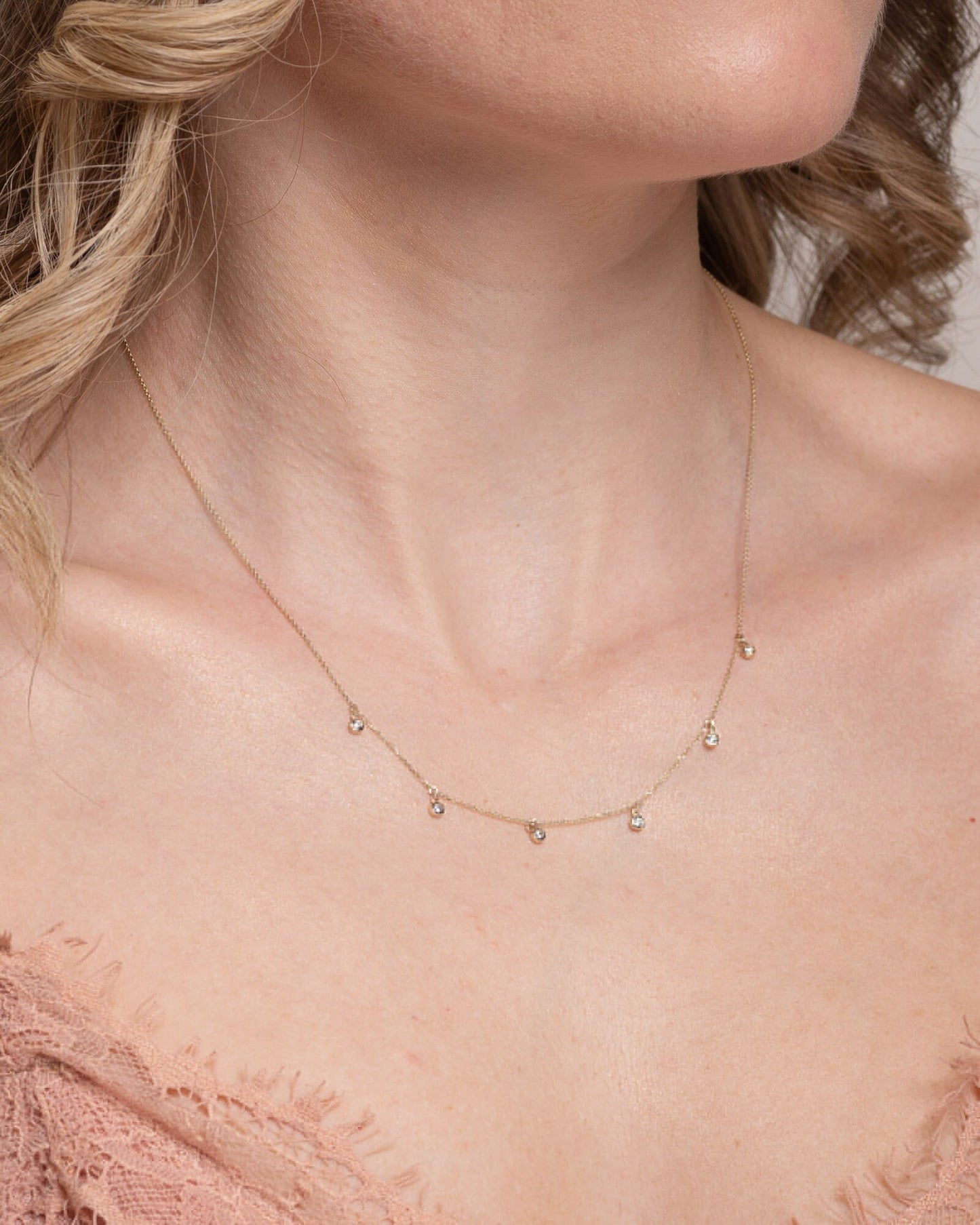 A model wearing a Cubic Zirconia By The Yard Station Necklace in 14k gold