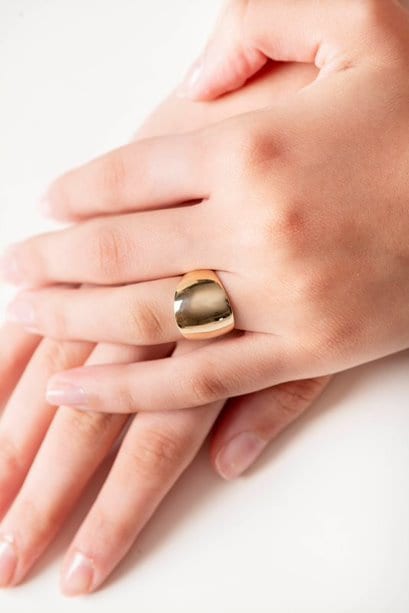 A large dome-shaped signet ring for women, crafted in 14k gold.