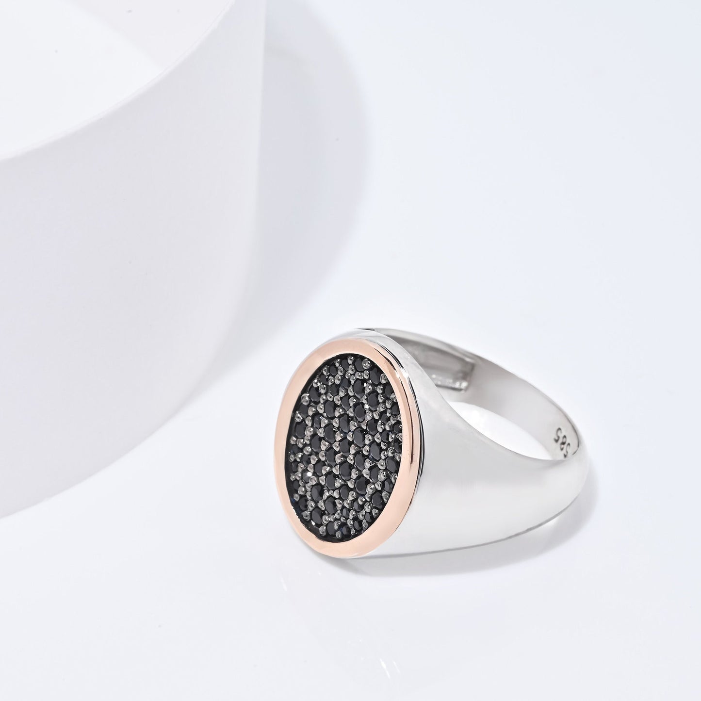 A two-tone signet ring for women, adorned with black cubic zirconia stones and set in 14k gold.