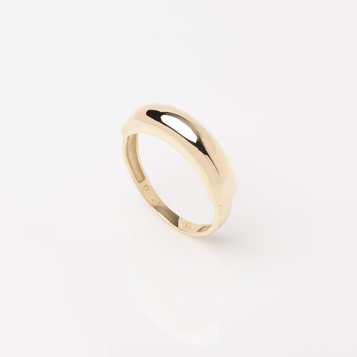 A dome ring for women crafted in 14k gold.