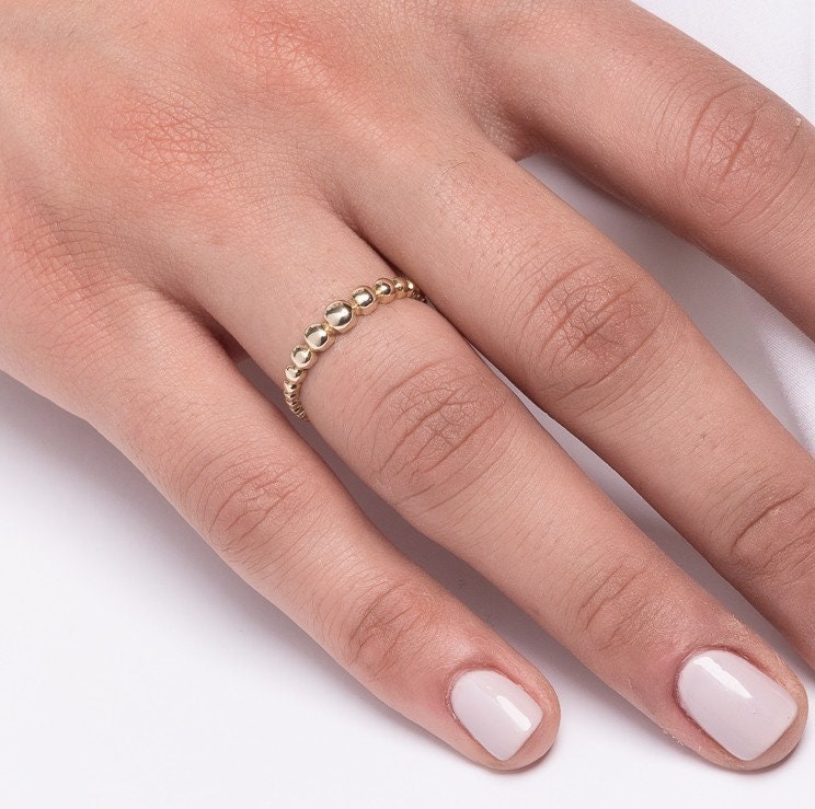 A beaded ring crafted from 14k solid gold for women.