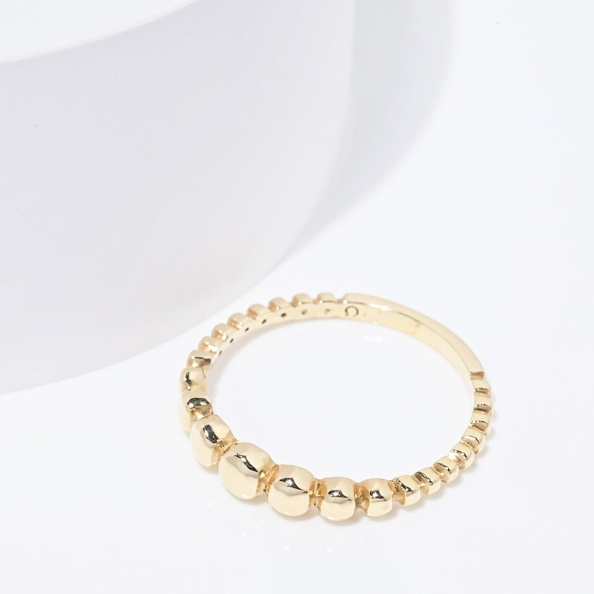 A beaded ring crafted from 14k solid gold for women.