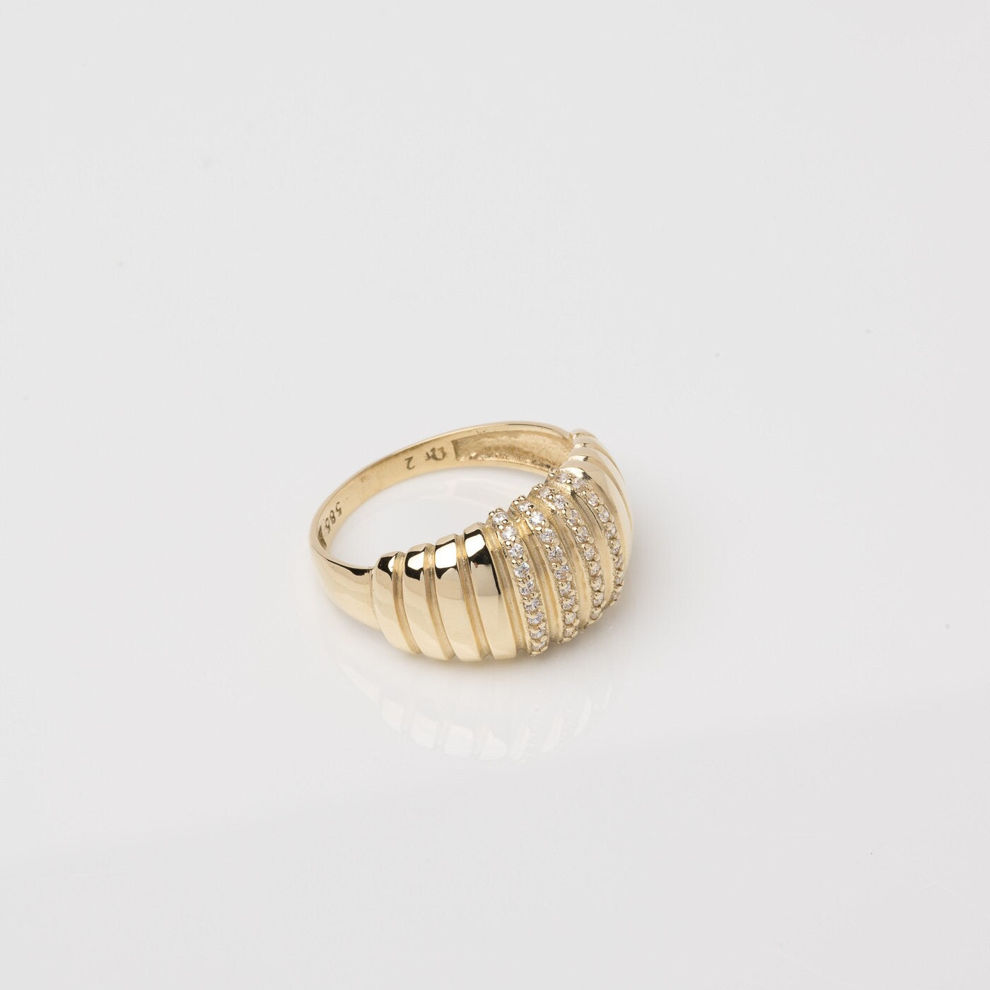 A Croissant Ring adorned with white cubic zirconia stones, set in 14k gold for women.