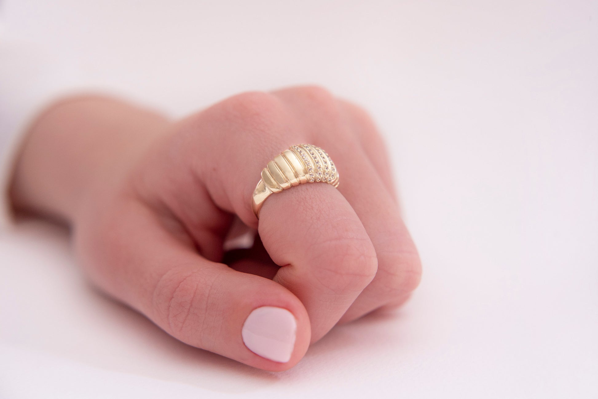 A Croissant Ring adorned with white cubic zirconia stones, set in 14k gold for women.