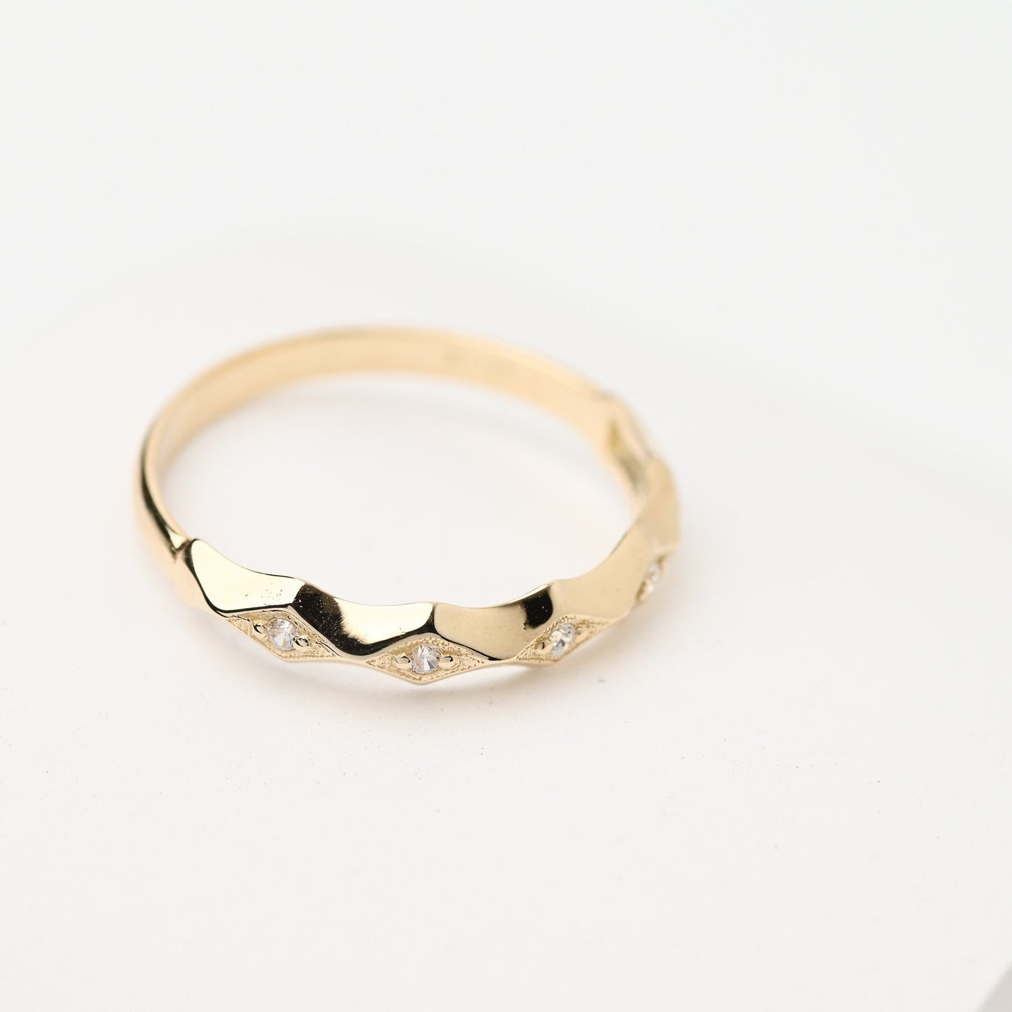 Handcrafted 14k gold ring adorned with white cubic zirconia stones, designed for women.