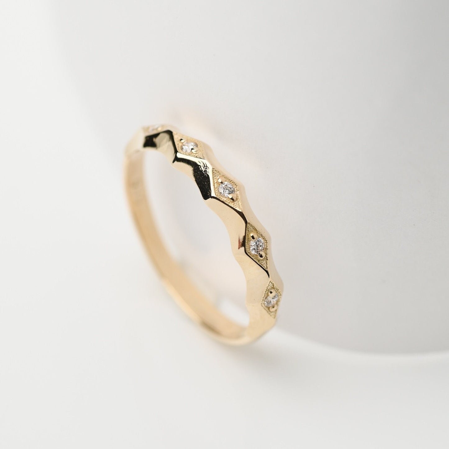 Handcrafted 14k gold ring adorned with white cubic zirconia stones, designed for women.