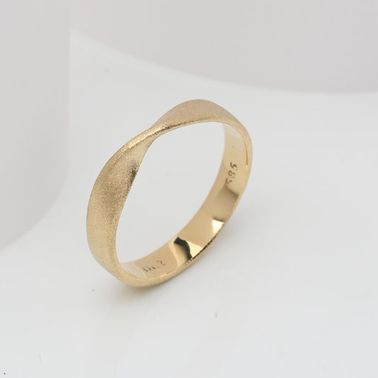 Sandblasted Möbius Ring in 14k solid gold for women.