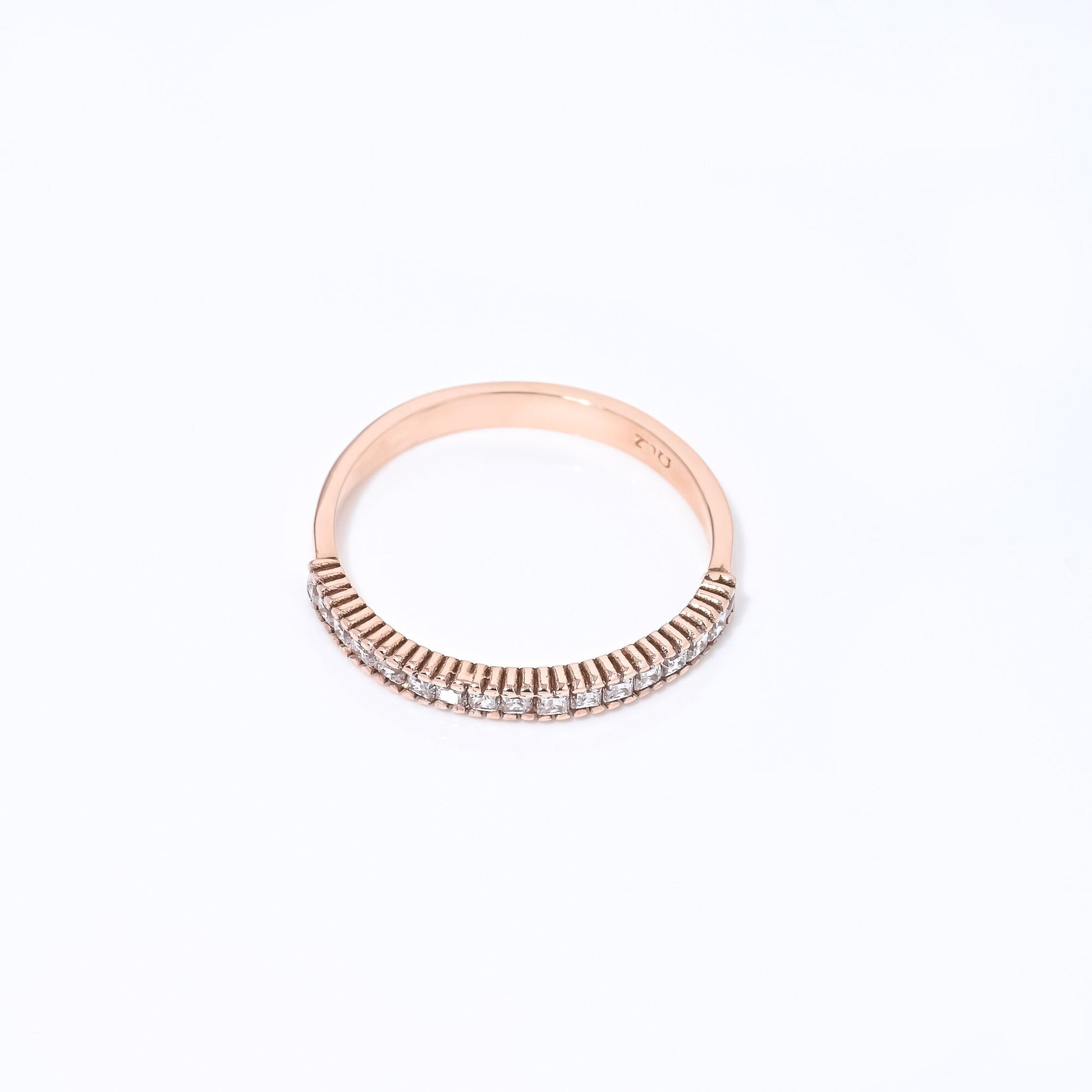 A half eternity band ring crafted in 14k solid gold, featuring white cubic zirconia stones in a prong setting.