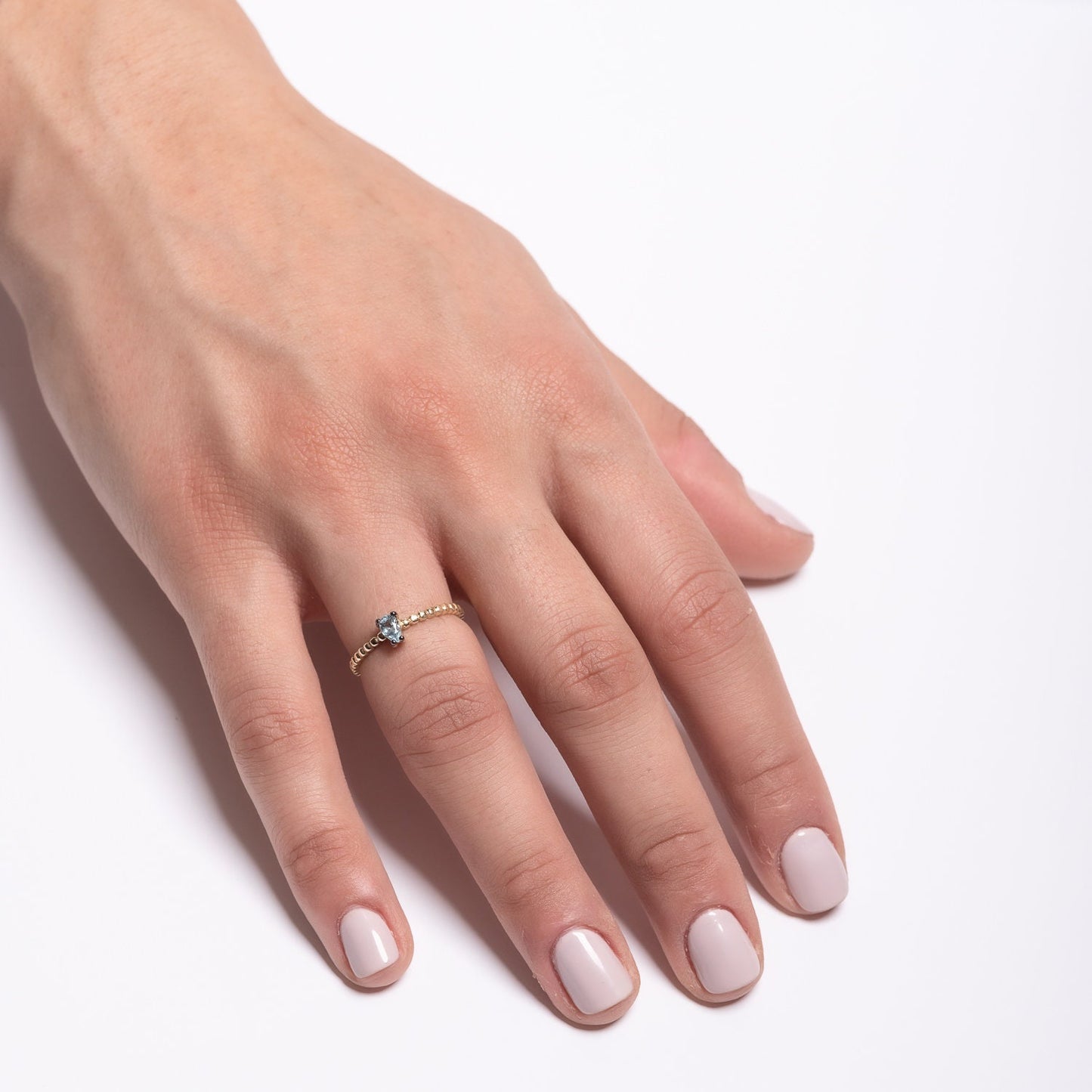 An aquamarine beaded ring in 14k gold, featuring a teardrop shape.