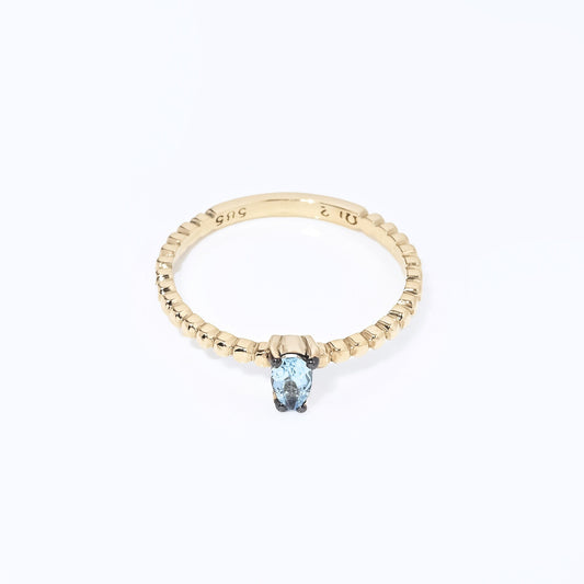 An aquamarine beaded ring in 14k gold, featuring a teardrop shape.