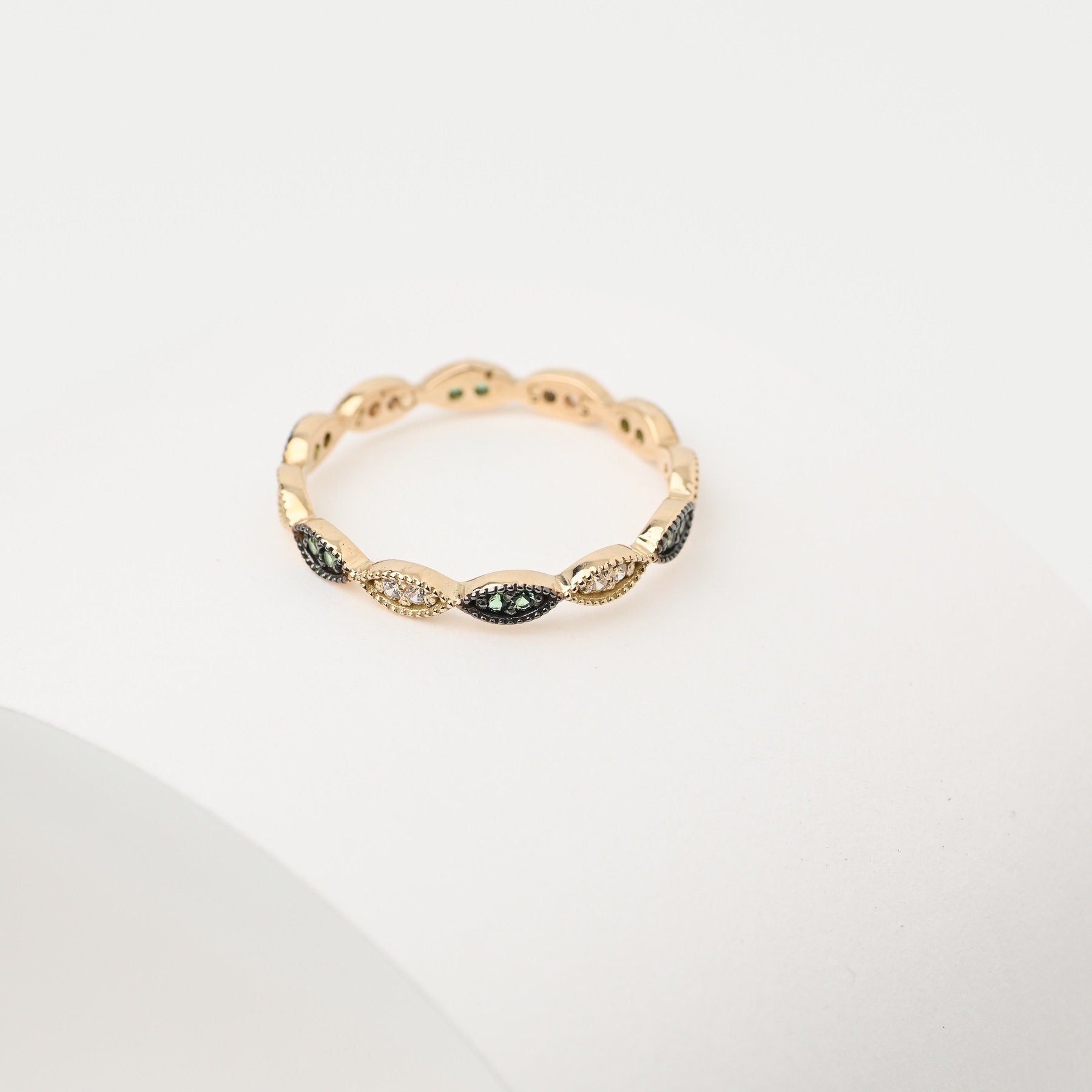 Handmade full eternity ring featuring white and green cubic zirconia stones set in 14k solid gold.