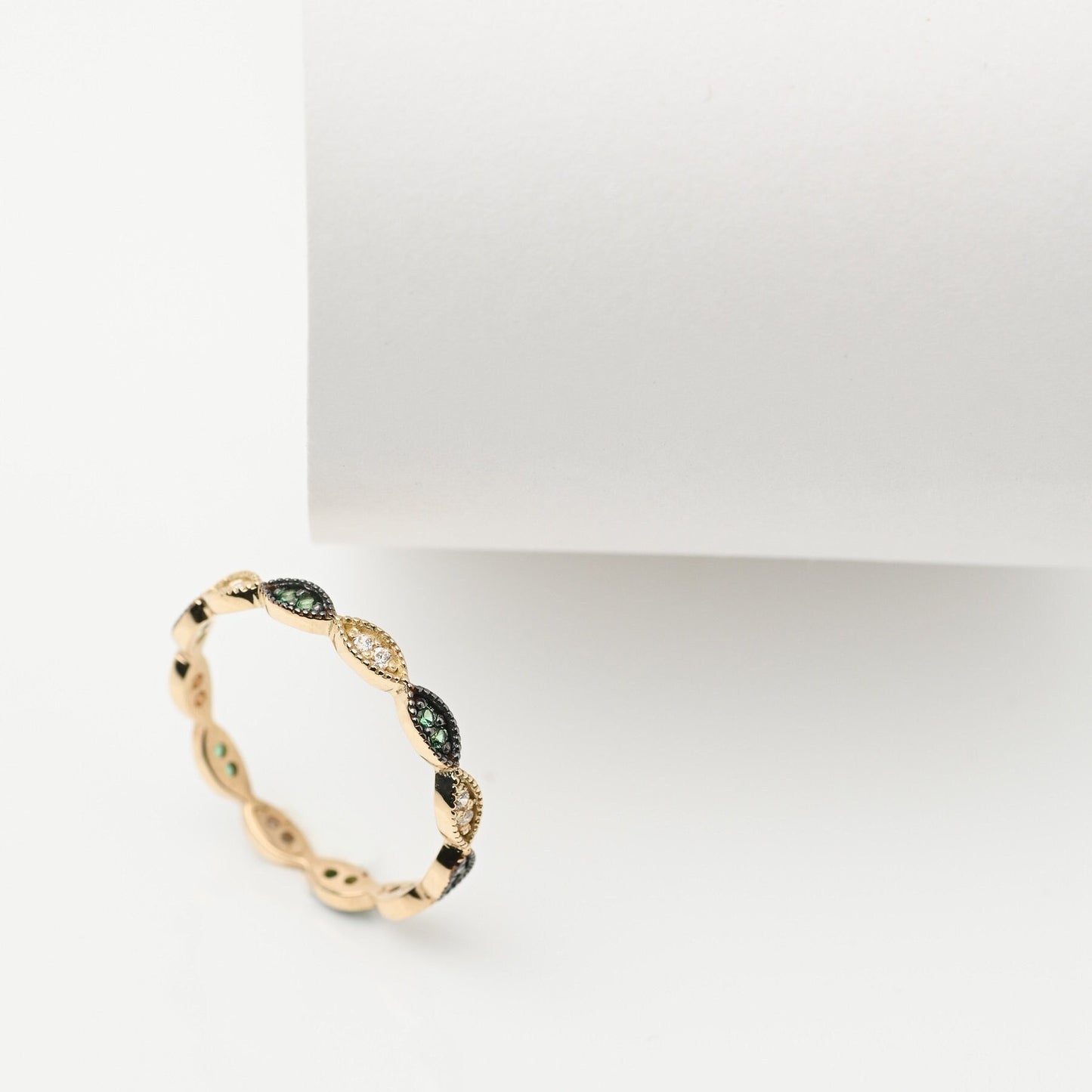 Handmade full eternity ring featuring white and green cubic zirconia stones set in 14k solid gold.