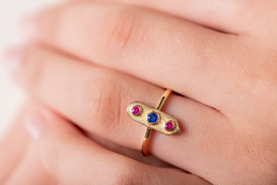 Handcrafted arrow-shaped gold ring with three gemstones set in 14k solid gold.