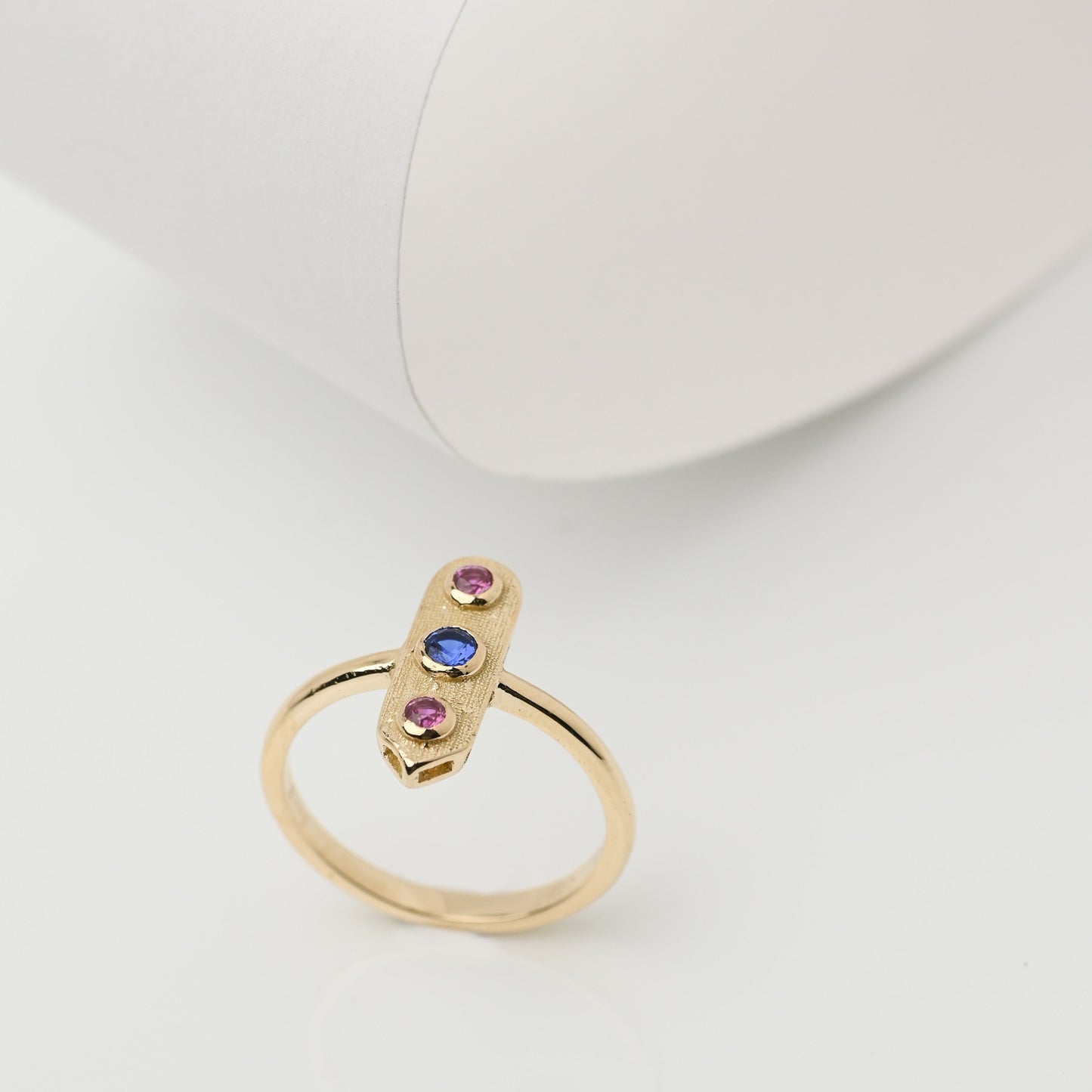 Handcrafted arrow-shaped gold ring with three gemstones set in 14k solid gold.