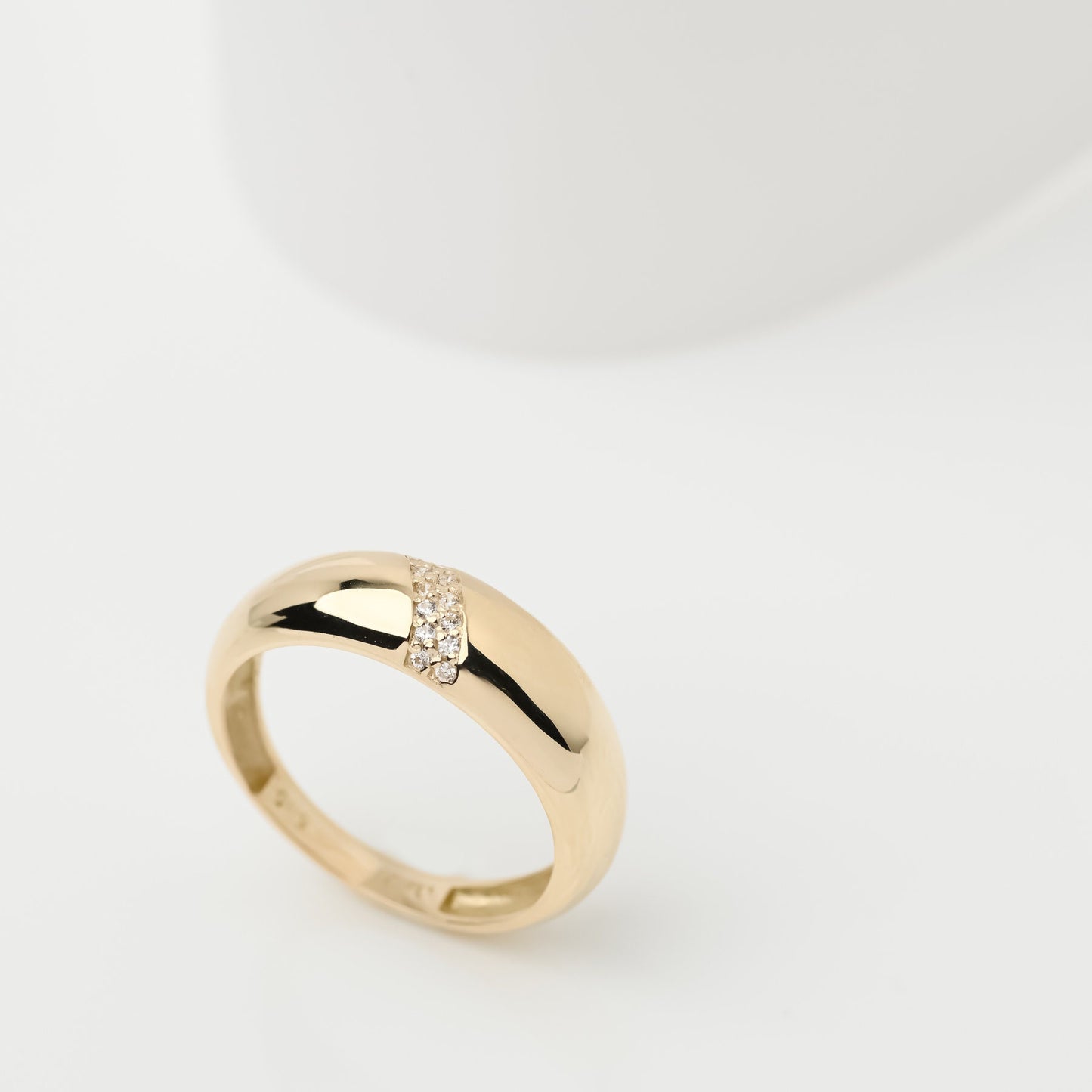 Handmade dome ring in 14k solid gold, partially paved with white cubic zirconia stones.