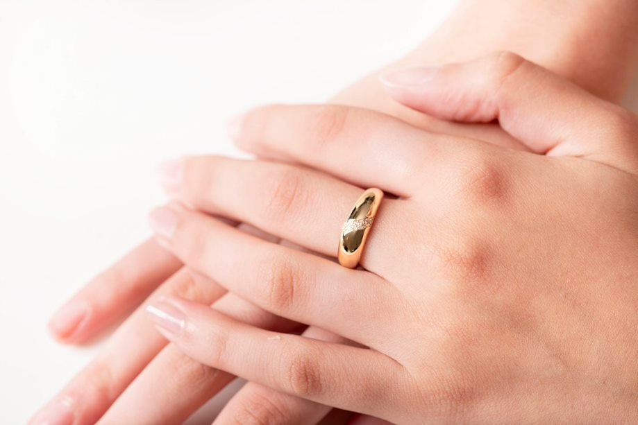 Handmade dome ring in 14k solid gold, partially paved with white cubic zirconia stones.