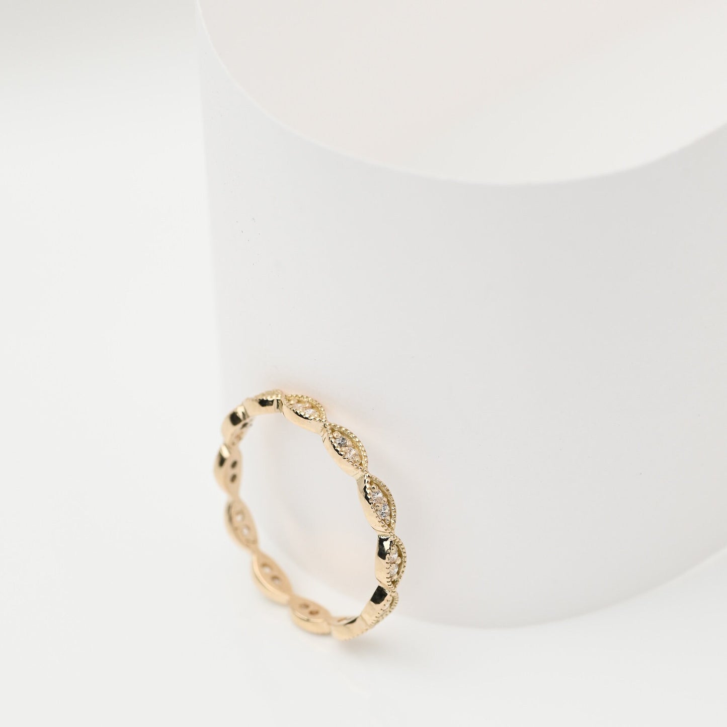 Handmade Eretiny band ring crafted in 14k gold, adorned with white cubic zirconia stones.