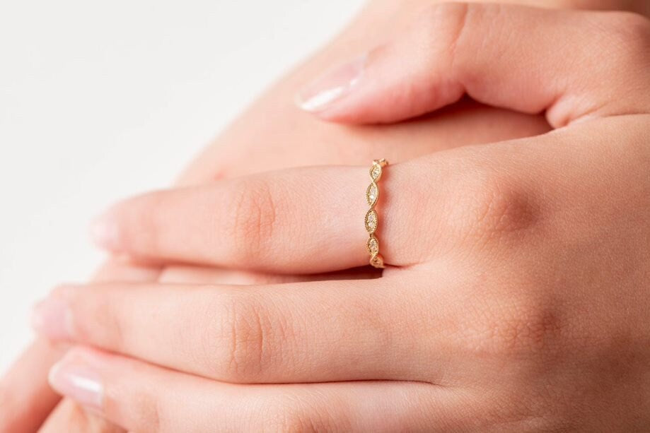 Handmade Eretiny band ring crafted in 14k gold, adorned with white cubic zirconia stones.