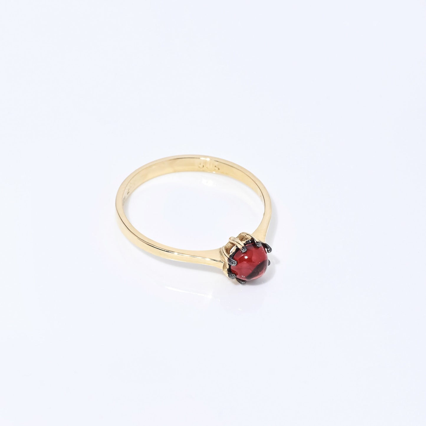 A natural garnet ring set in a 14k solid gold prong setting, designed for women.