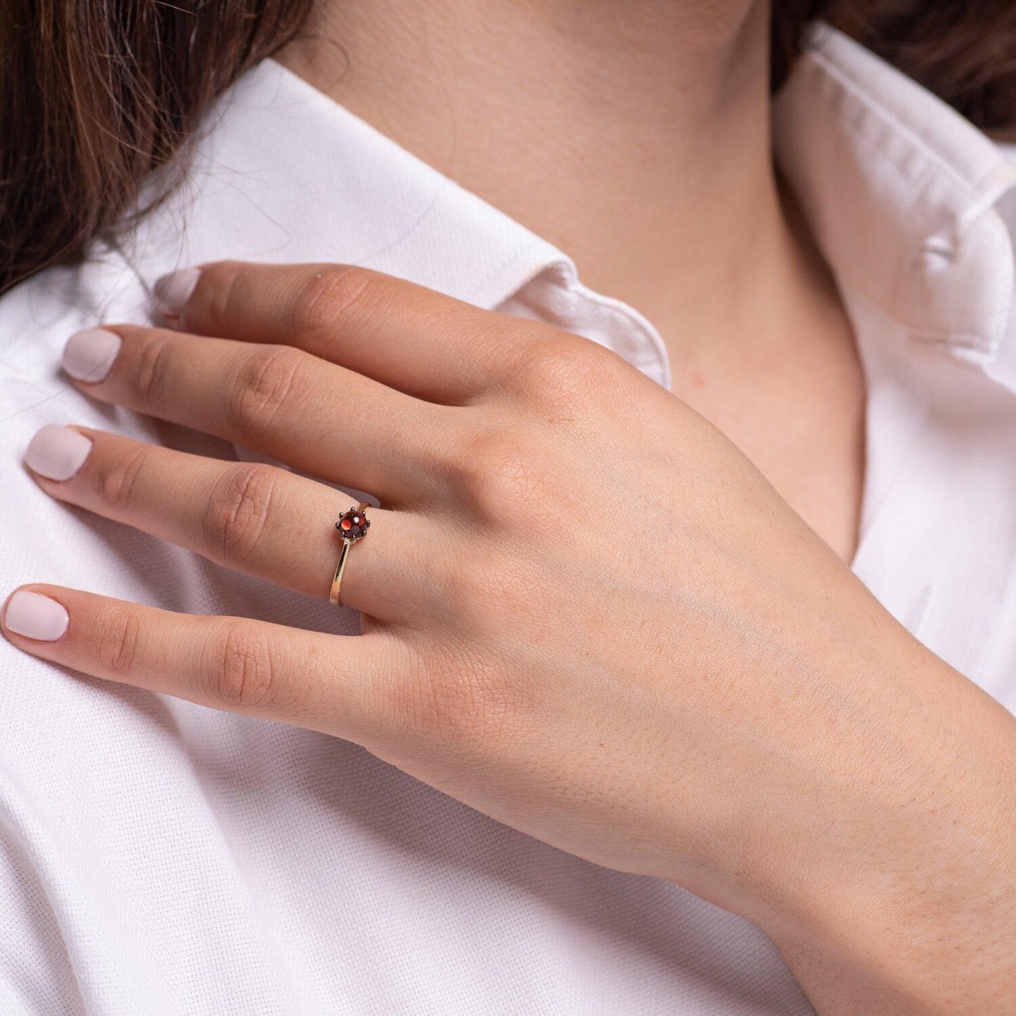 A natural garnet ring set in a 14k solid gold prong setting, designed for women.