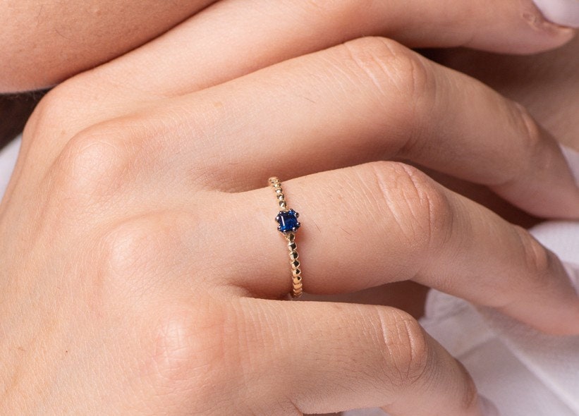 Handmade sapphire beaded ring for women, set in 14k gold with a prong setting.