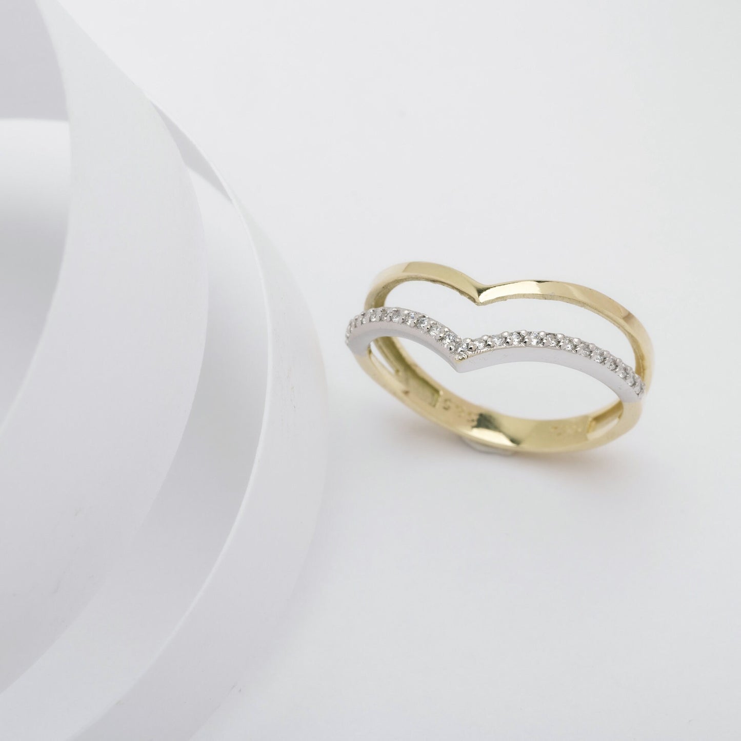 The Double Chevron Ring features a section paved with white cubic zirconia stones, set in 14k solid gold, and is handcrafted for women.