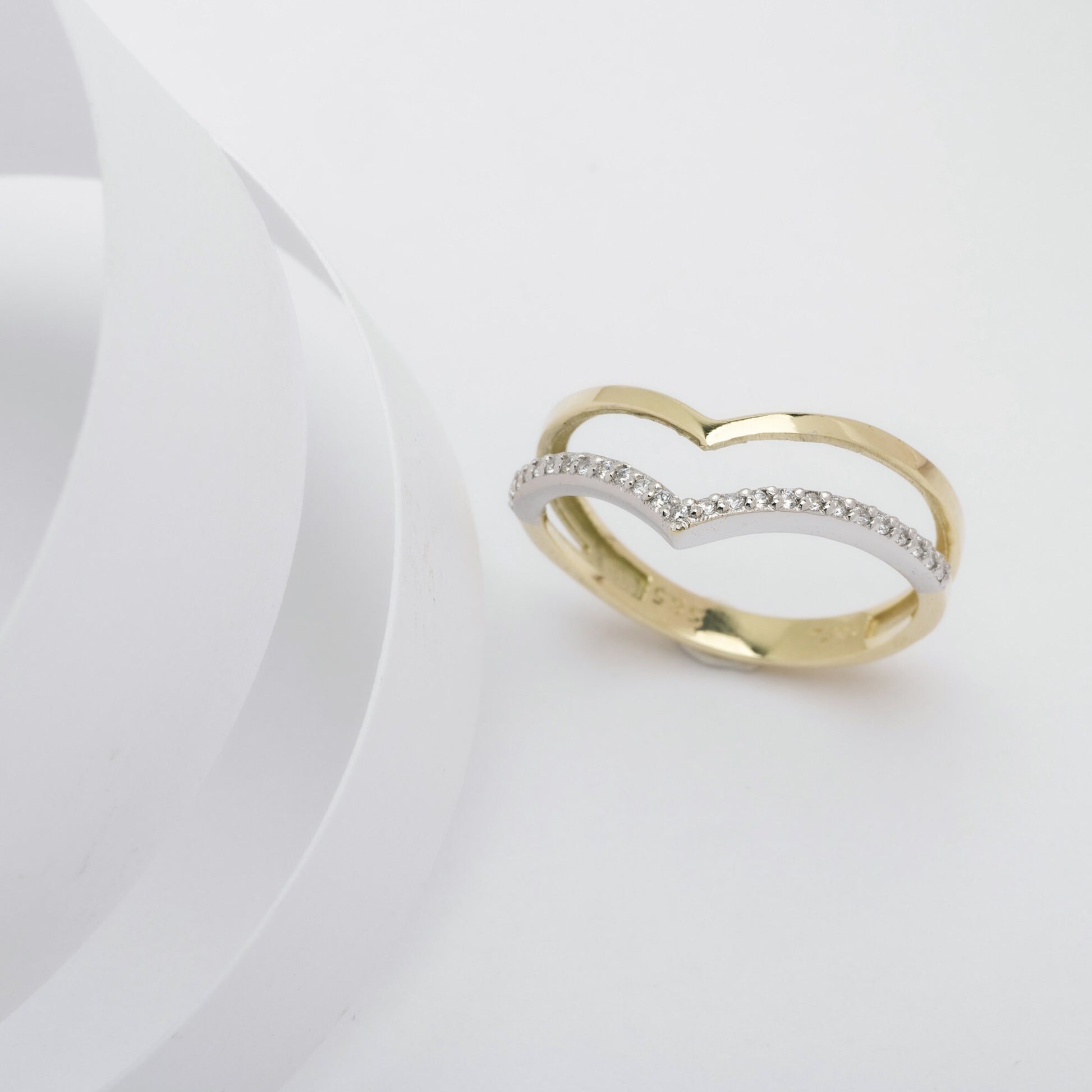 The Double Chevron Ring features a section paved with white cubic zirconia stones, set in 14k solid gold, and is handcrafted for women.