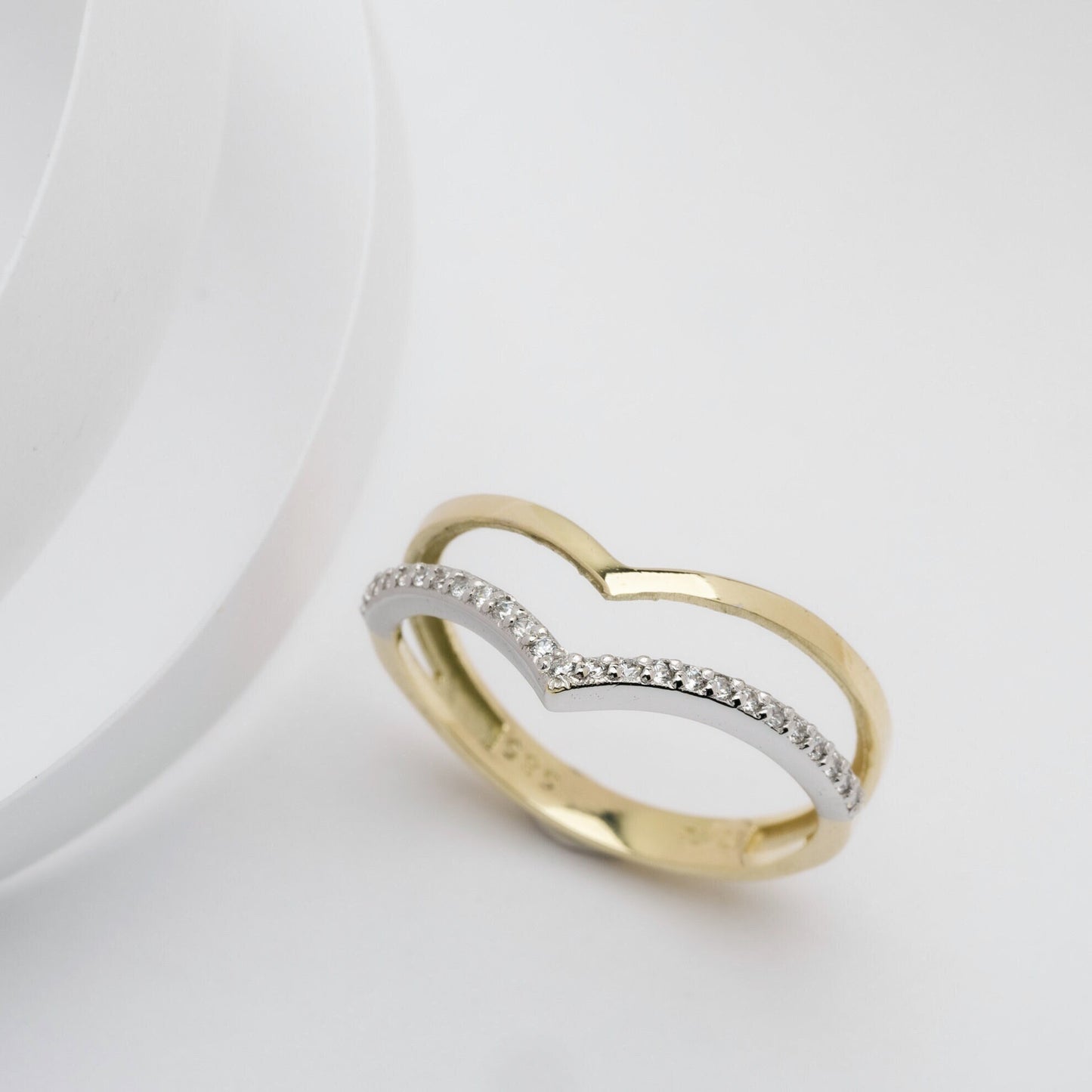 The Double Chevron Ring features a section paved with white cubic zirconia stones, set in 14k solid gold, and is handcrafted for women.