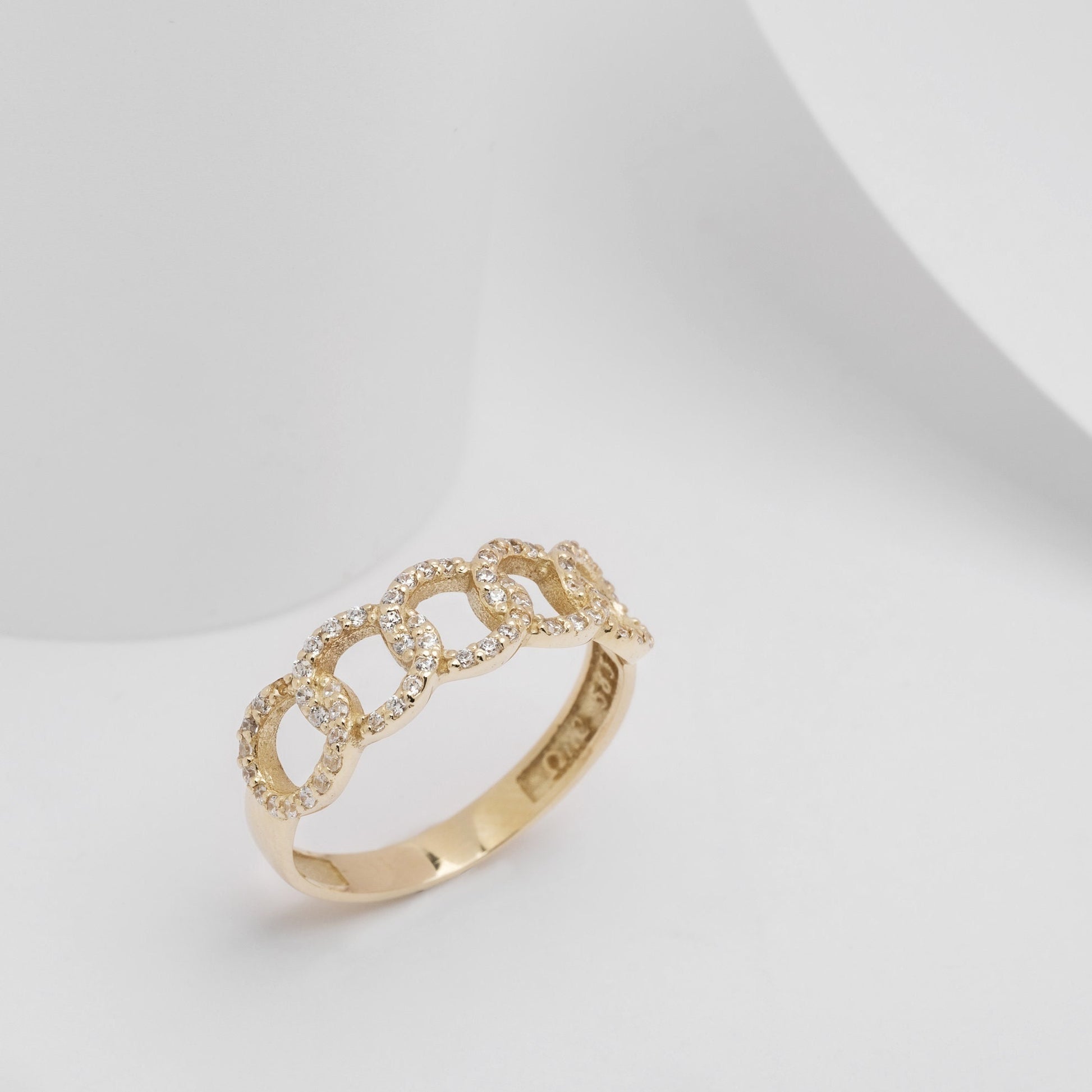 A handmade chain ring crafted in 14k solid gold, embellished with white cubic zirconia stones.