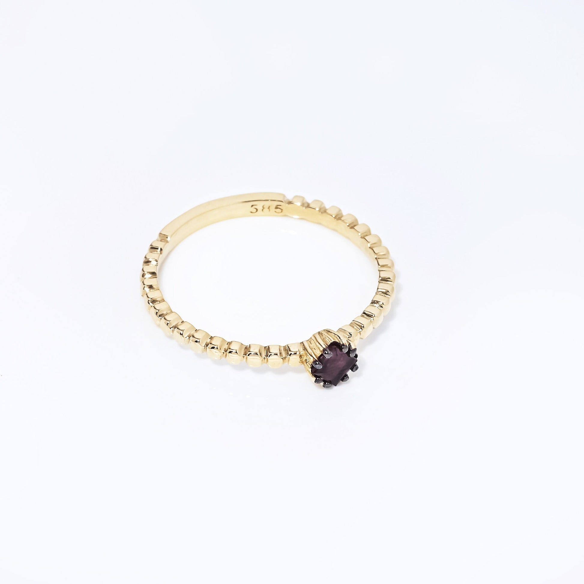 A women's Ruby Solitaire Ring, crafted in 14k gold with a beaded design.