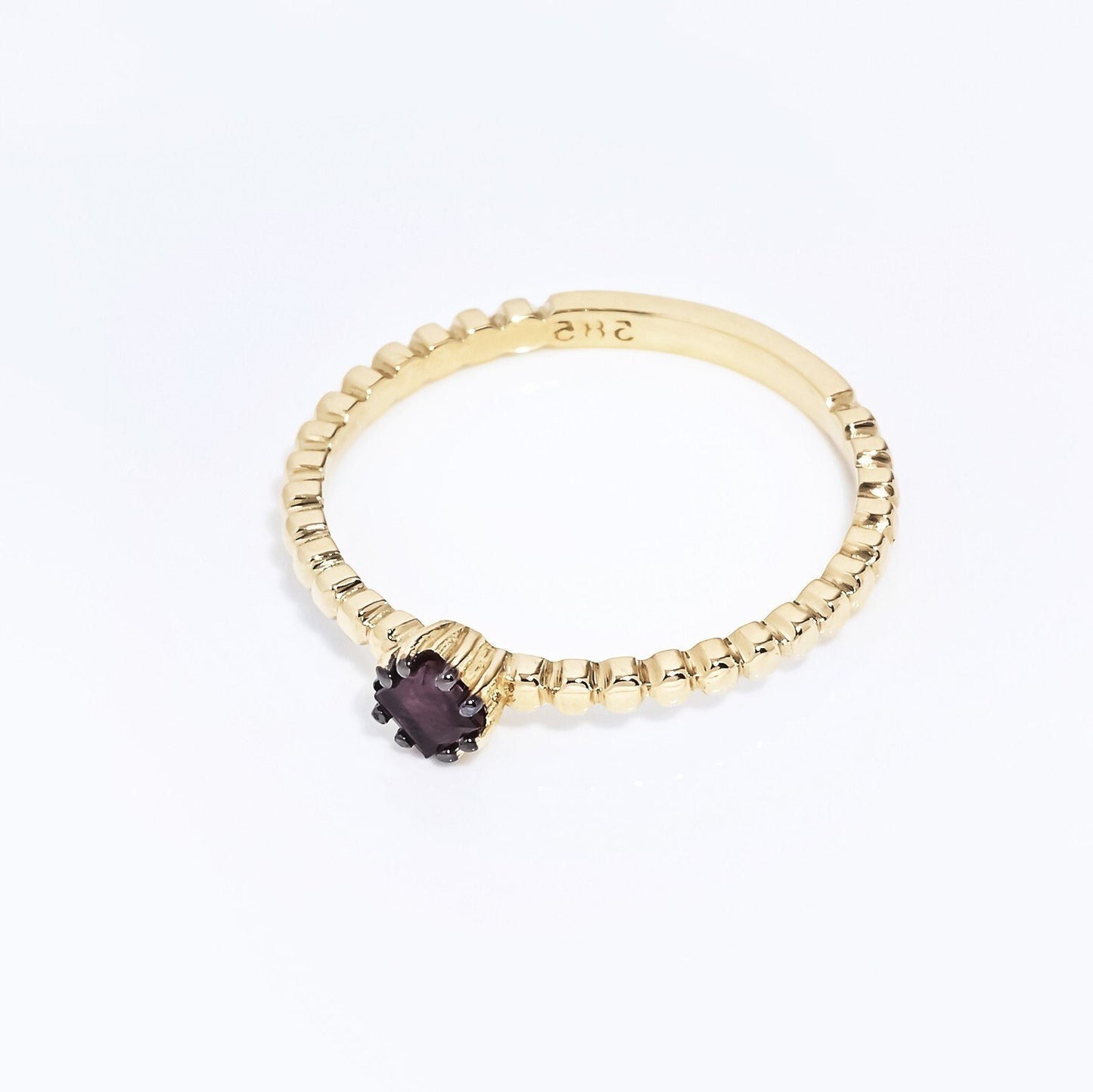 A women's Ruby Solitaire Ring, crafted in 14k gold with a beaded design.