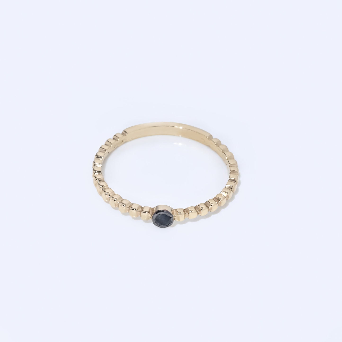 Handmade beaded ring featuring a single birthstone in a bezel setting.