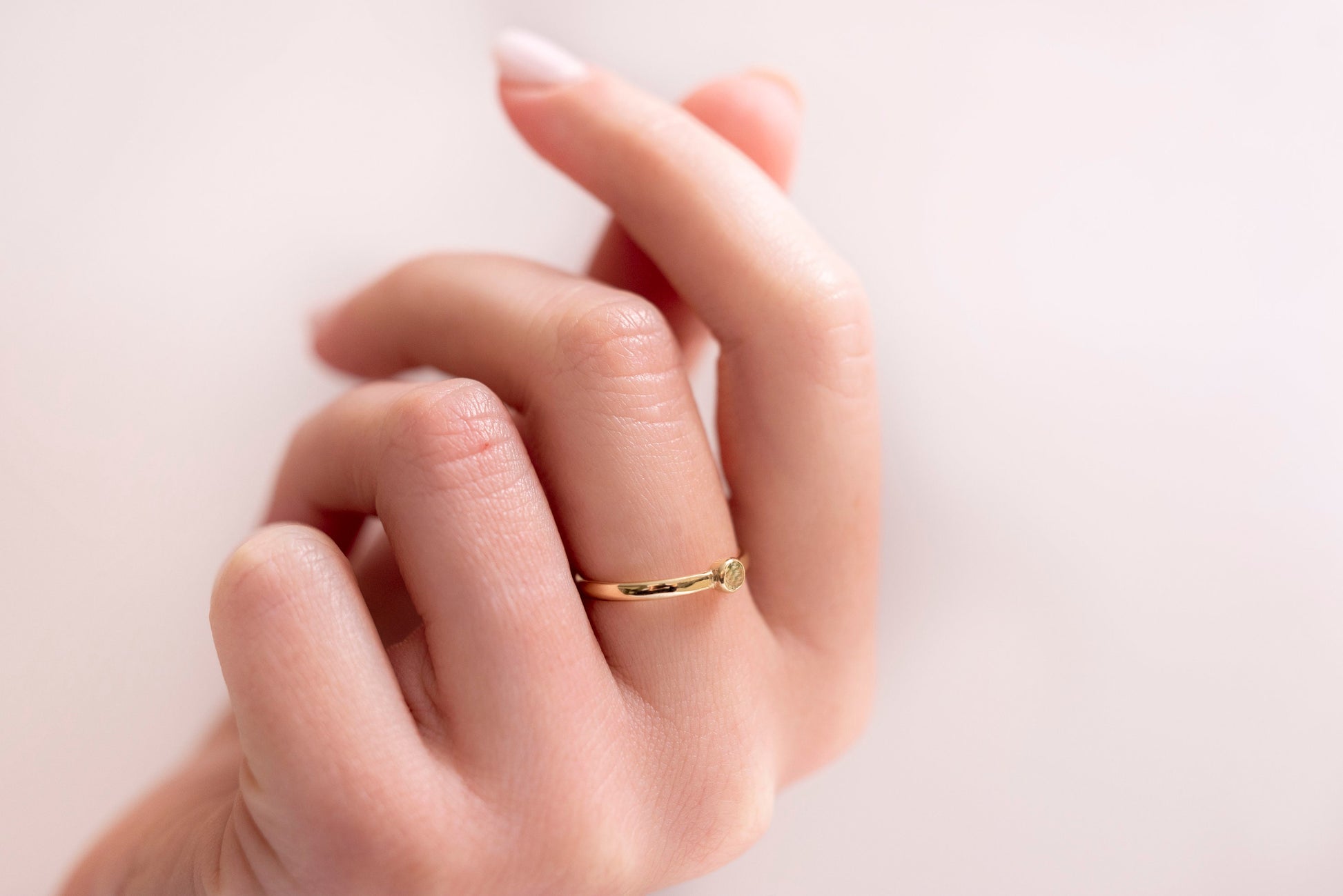 A handmade birthstone ring crafted in 14k solid gold, featuring a single stone in a bezel setting.